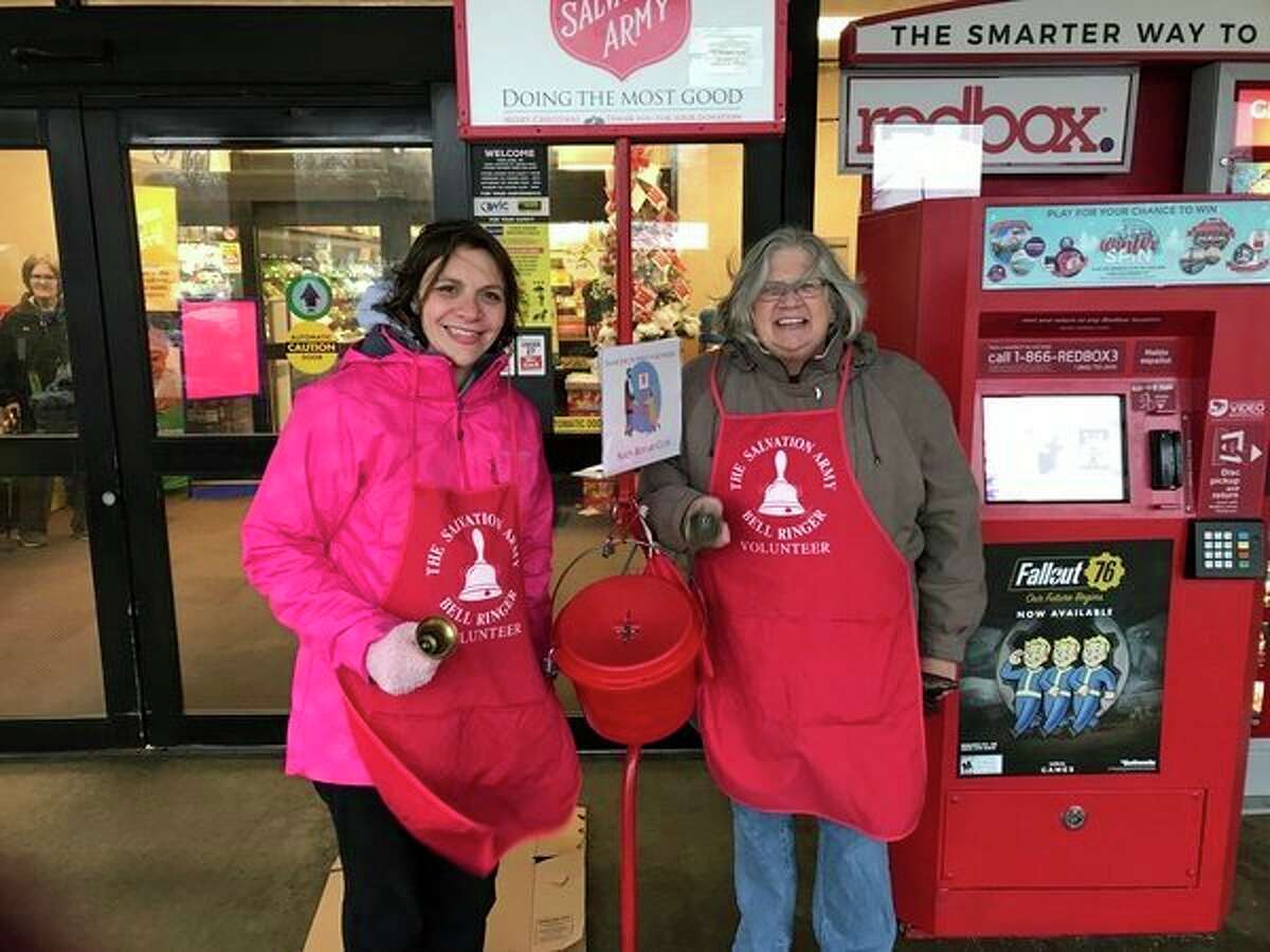 Rotarians Teresa George and Melissa Barnard volunteer with the Salvation Army Red Kettle Fundraiser in a past year. (Photo provided)  