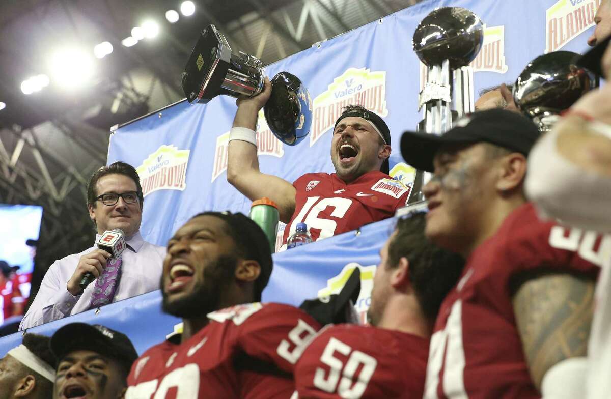 Washington State quarterback Gardner Minshew (16) reacts after receiving the offensive player of the game trophy as the Cougars defeat Iowa State in the 2019 Valero Alamo Bowl at the Alamodome on Friday, Dec. 28, 2018. The Cougars defeated the Cyclones, 28-26. (Kin Man Hui/San Antonio Express-News)