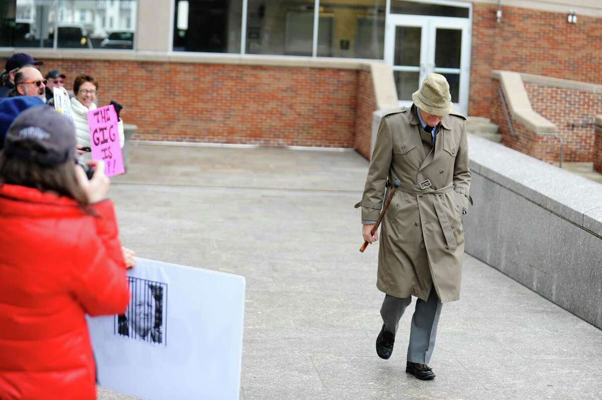 Chris Von Keyserling, a member of Greenwich's Representative Town Meeting, walks past protestors towards Stamford Superior Court in Stamford, Conn. on Wednesday, Feb. 22, 2017. Von Keyserling was arrested on Jan. 11 and charged with a class A misdemeanor after allegedly groping a woman after the two had an argument.