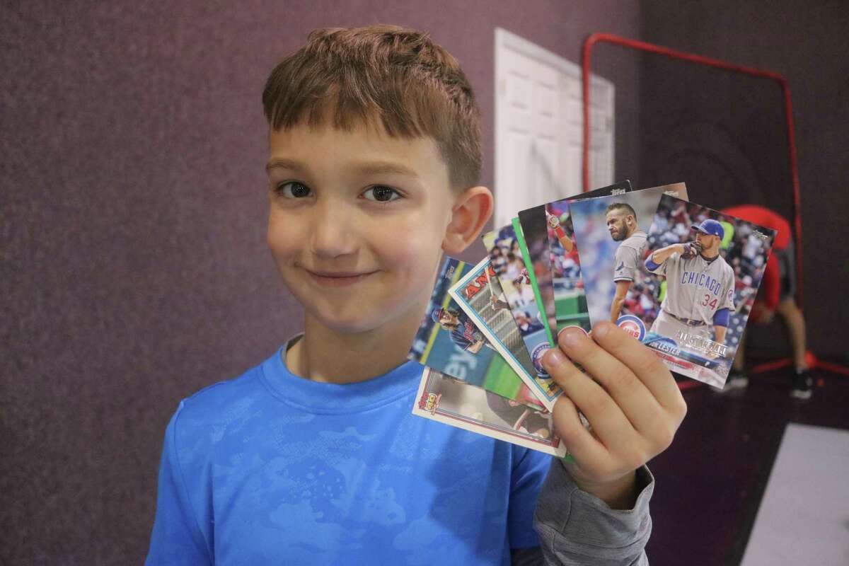 Braxton Landers displays the many baseball cards he received from the camp staff for his work at improving his hitting on Day 1 of the annual Holiday Baseball Camp Thursday.
