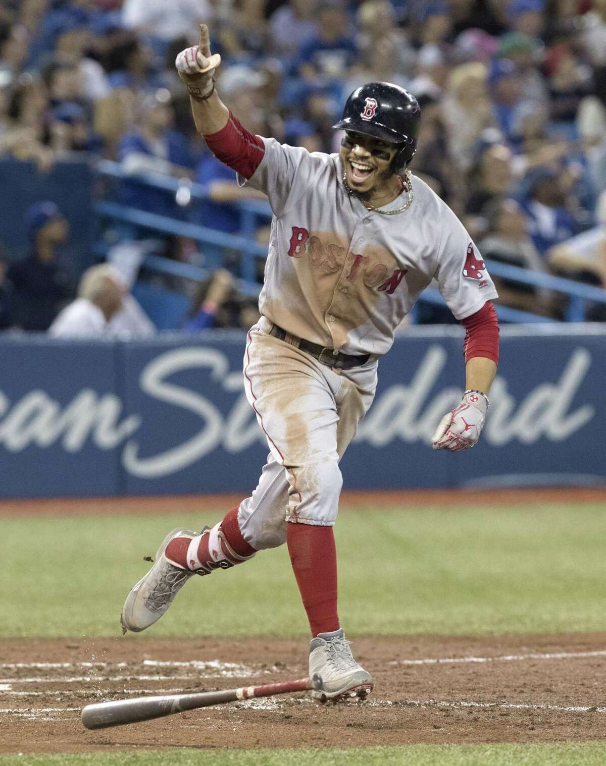 The Red Sox’s Mookie Betts celebrates after hitting a home run during the ninth inning against the Blue Jays on Aug. 9.
