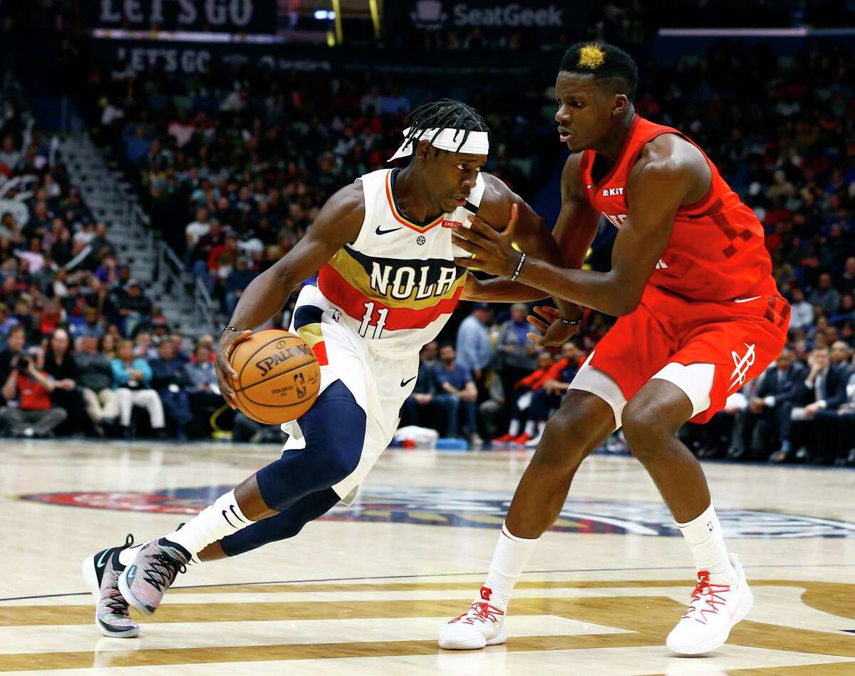 New Orleans Pelicans guard Jrue Holiday (11) drives to the basket around Houston Rockets center Clint Capela (15) during the second half of an NBA basketball game, Saturday, Dec. 29, 2018, in New Orleans. (AP Photo/Butch Dill)