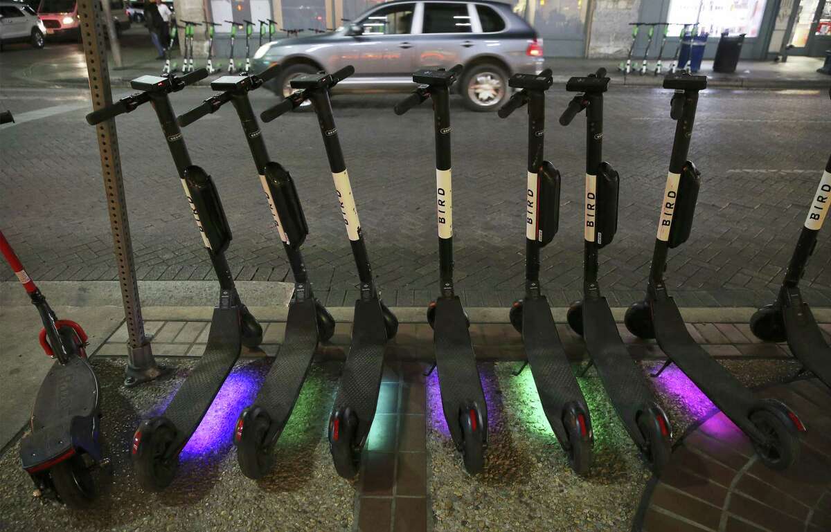 LED lights colorfully shine on a row of scooters in downtown San Antonio on Tuesday, Dec. 4, 2018. Scooters have rapidly made their presence felt in downtown San Antonio. For many users, the vehicle is a novelty and a handy method of transportation. But with the climbing growth of users, rules for their usage have been sketchy or unclear. Some users have gone as far as using them along the RiverWalk which is prohibited by the city. (Kin Man Hui/San Antonio Express-News)