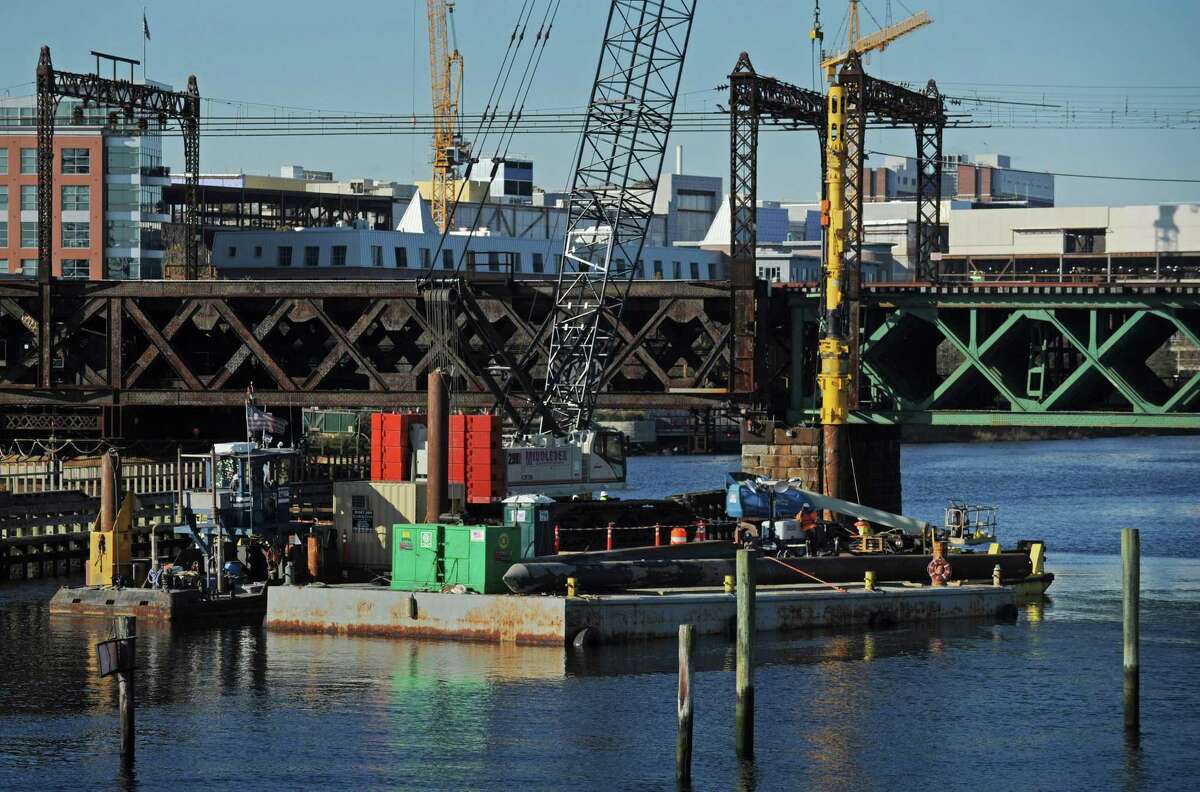 Middlesex Construction workers drive pilings from a barge in the Norwalk River, Thursday, November 8, 2018, in preparation for the Walk Bridge replacement project in Norwalk, Conn. The Connecticut Department of Transportation will hold two-session public information meeting at Norwalk City Hall Nov. 28 to update the public on the Walk Bridge replacement environmental impacts and mitigation, recently completed and upcoming construction activities and ?‘findings from the archeological excavation.?’