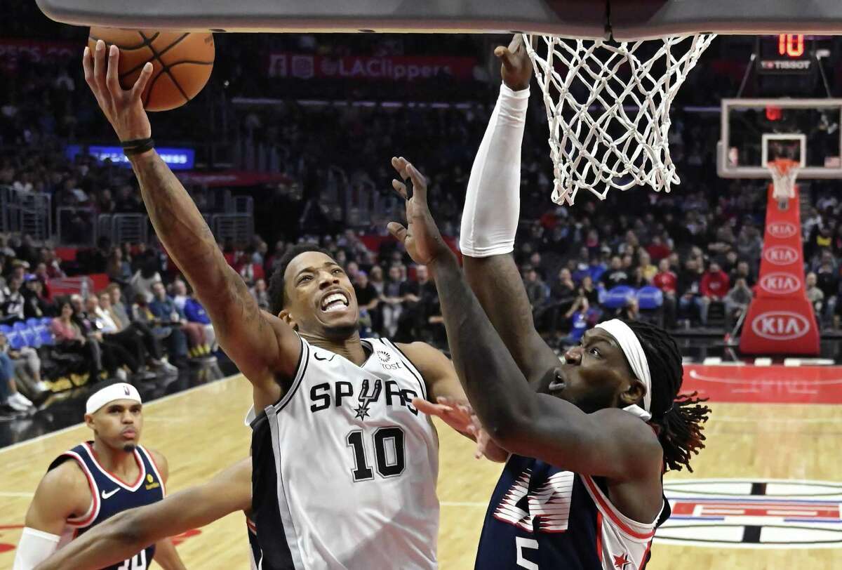 Spurs guard DeMar DeRozan shoots over Clippers forward Montrezl Harrell on Saturday, when DeRozan had 25 points and 13 rebounds in the Spurs’ 122-111 victory.