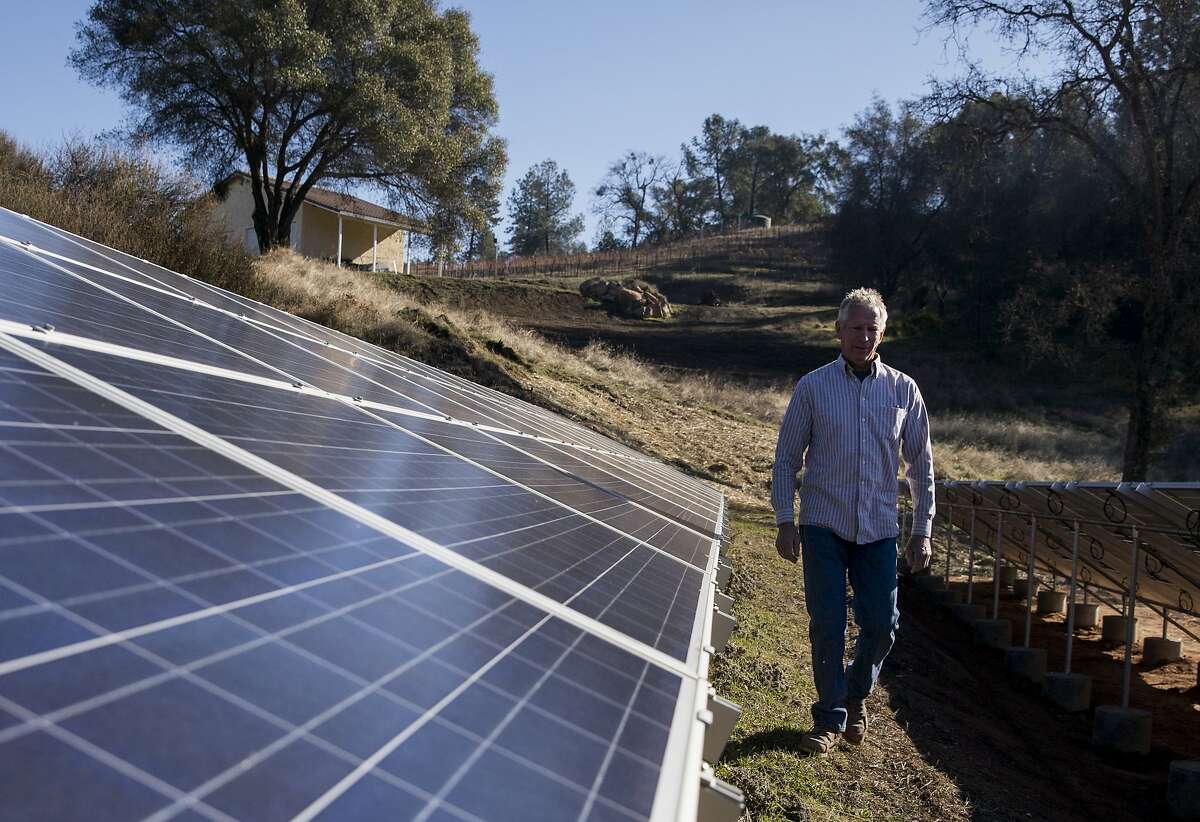 Contractor Kirk Reuter walks through solar panels he recently installed on the property of La Mesa Vineyards in Plymouth, Calif. Saturday, Dec. 29, 2018.