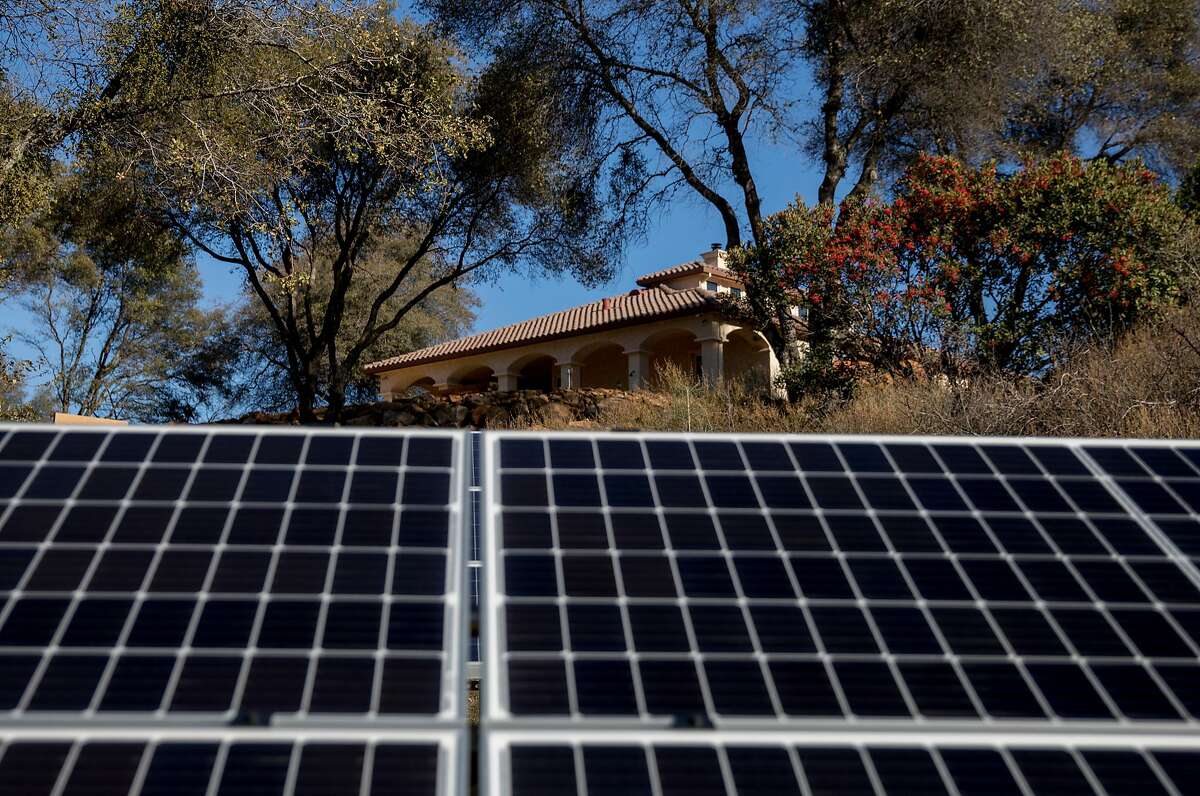 The home of vineyard owner Come Lague peeks out above newly-installed solar panels at La Mesa Vineyards in Plymouth, Calif. Saturday, Dec. 29, 2018.