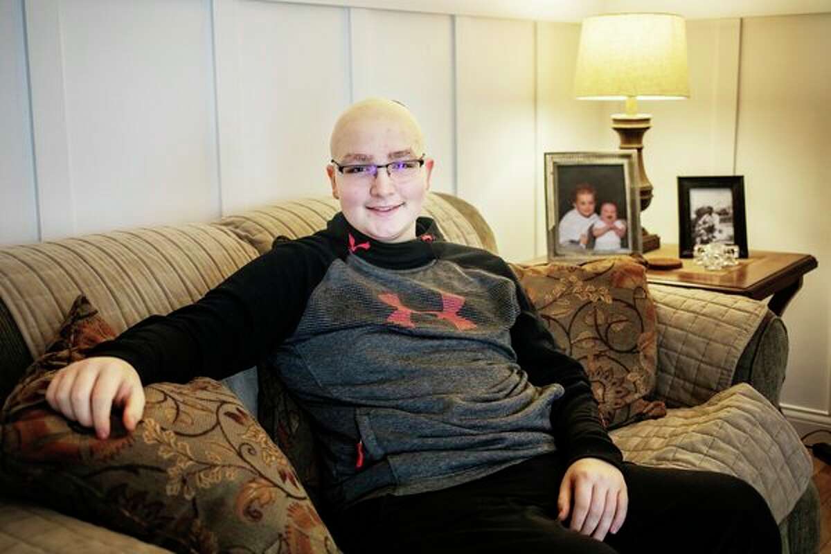 Tyler Wirth, 13, poses for a photo at his home in Midland on Saturday. Wirth returned to Midland Dec. 21 from Cincinnati Children's Hospital in southern Ohio, where he had been staying since Oct. 8. to receive radiation treatments for cancer in his spinal cord. (Katy Kildee/kkildee@mdn.net)