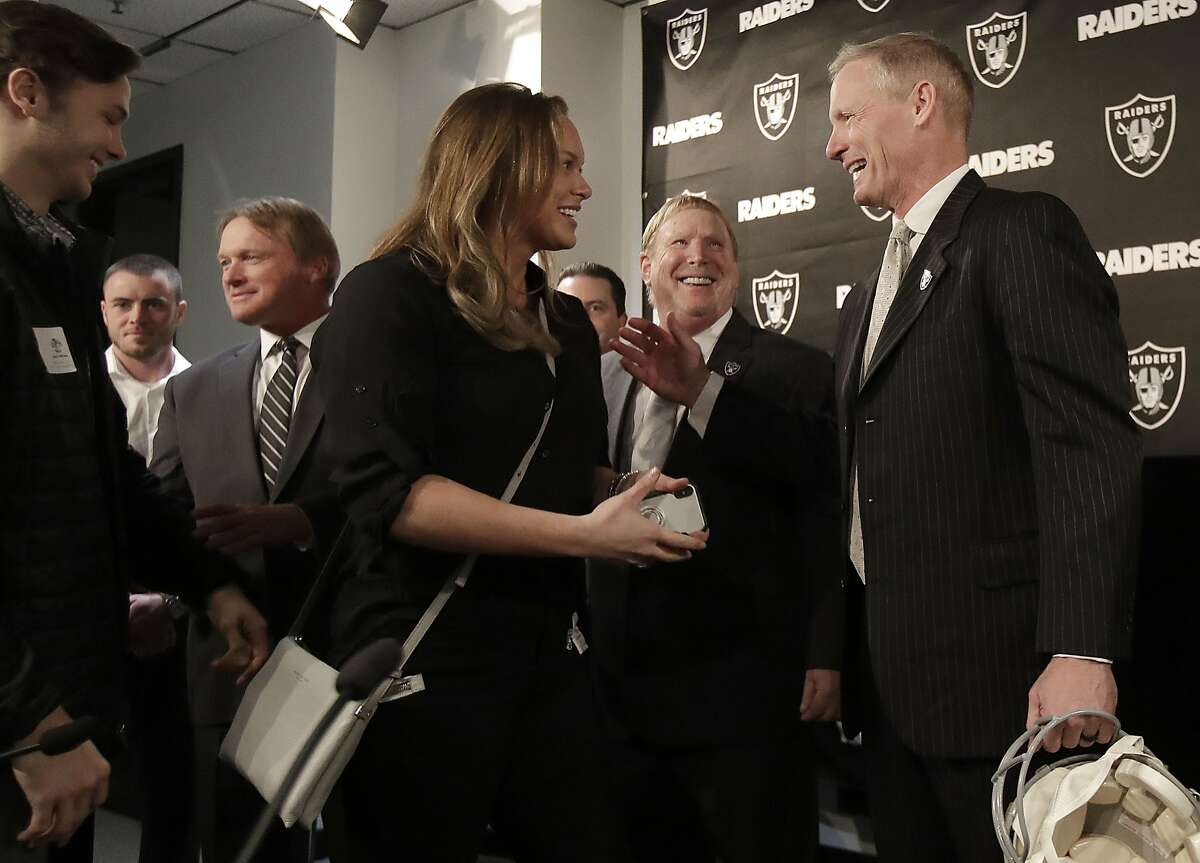 Mike Mayock, right, introduces members of his family to Oakland Raiders owner Mark Davis, second from right, and head coach Jon Gruden, third from left, at a news conference announcing Mayock as the team's general manager in Oakland, Calif., Monday, Dec. 31, 2018. (AP Photo/Jeff Chiu)