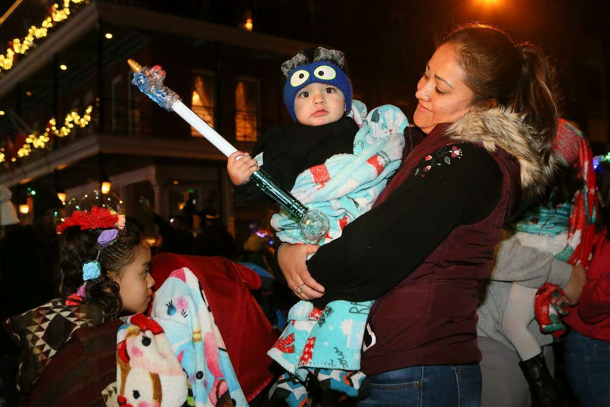 One-year-old Dylan Carretero brings in the New Year with his mother, Maria Carretero, at the city's giant New Year's Eve party downtown at Hemisfair on Monday, Dec. 31, 2018.