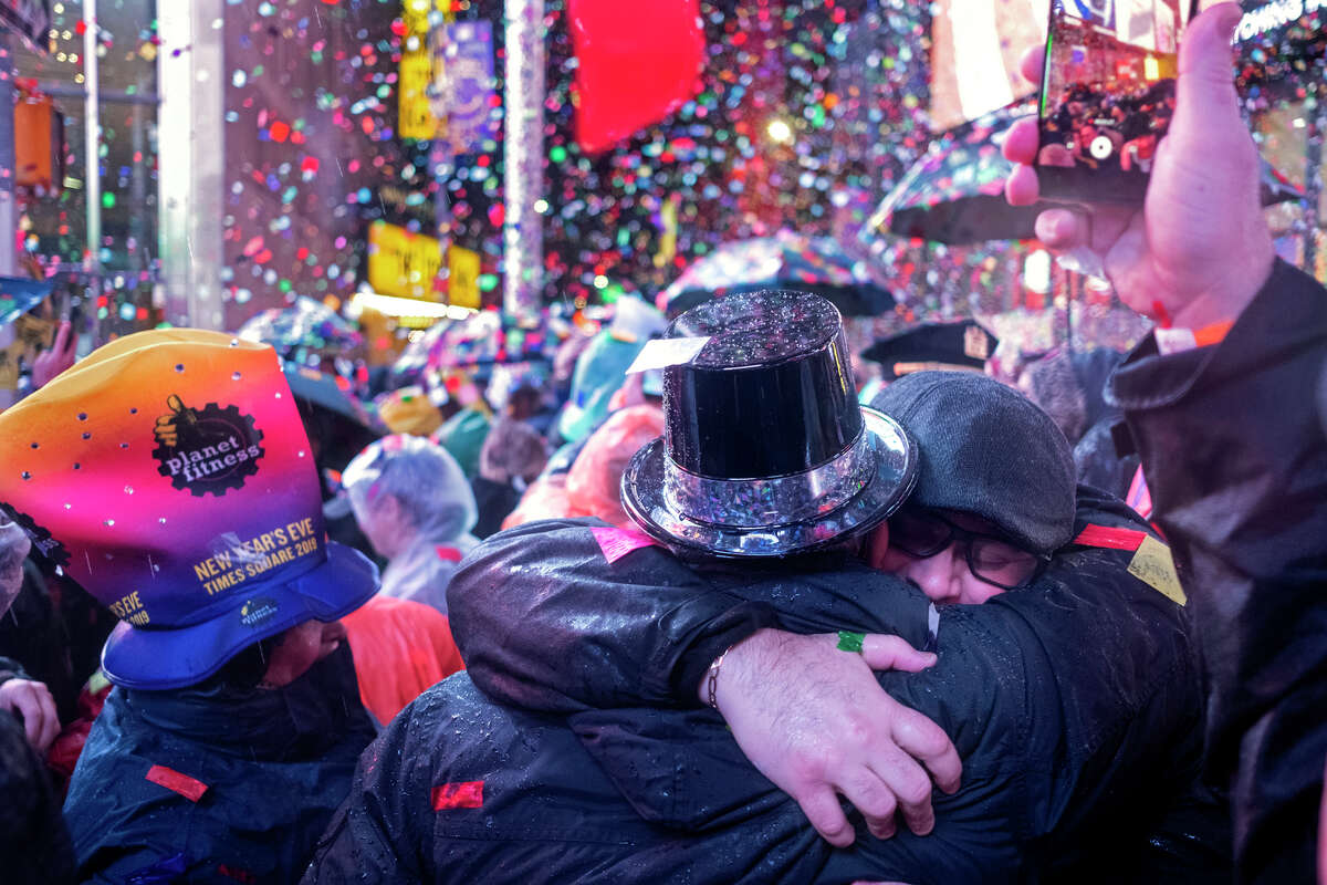 Revelers embrace in Times Square in New York, Tuesday, Jan. 1, 2019, during a New Year's celebration.