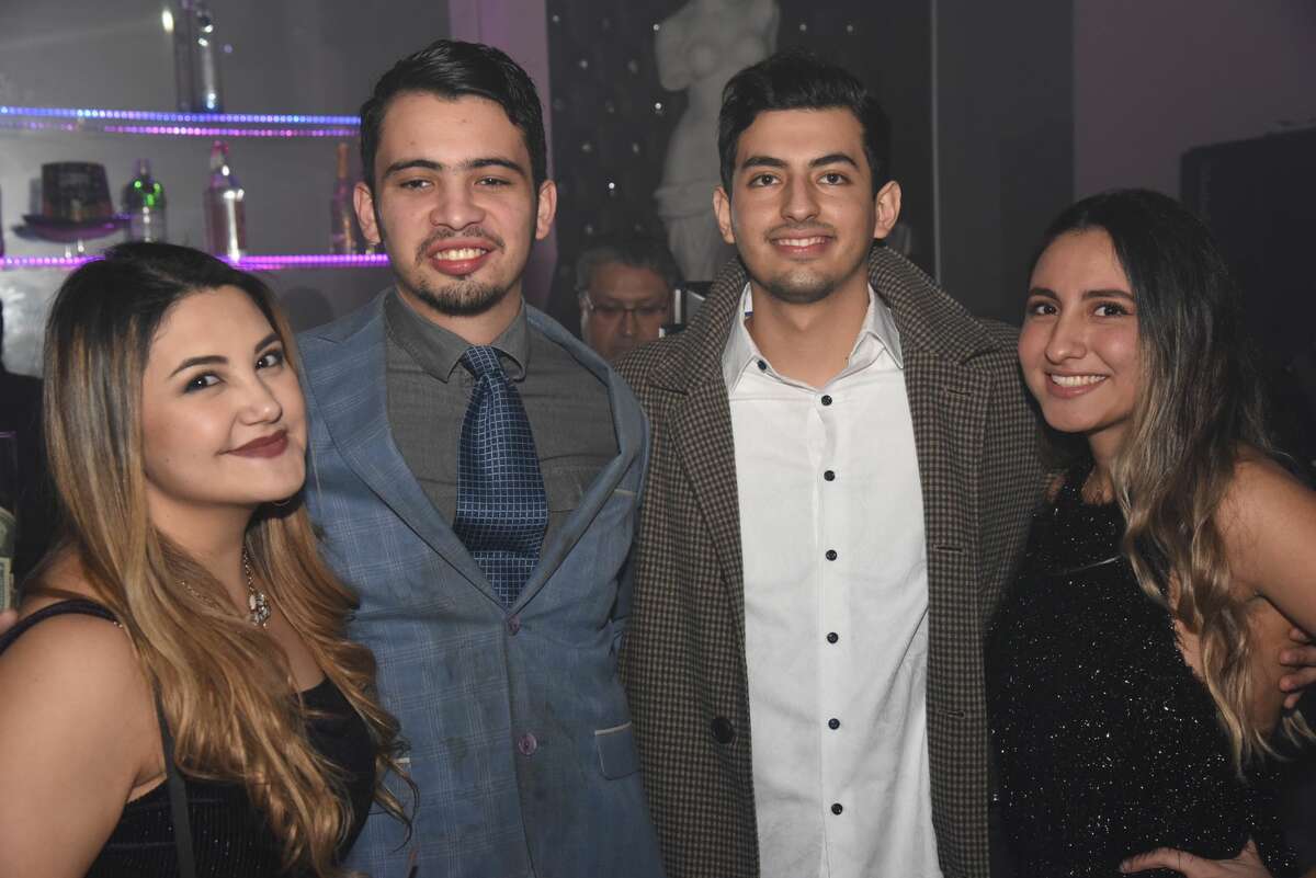 Attendees pose for a photo during the Dolce Nightclub New Years Party.