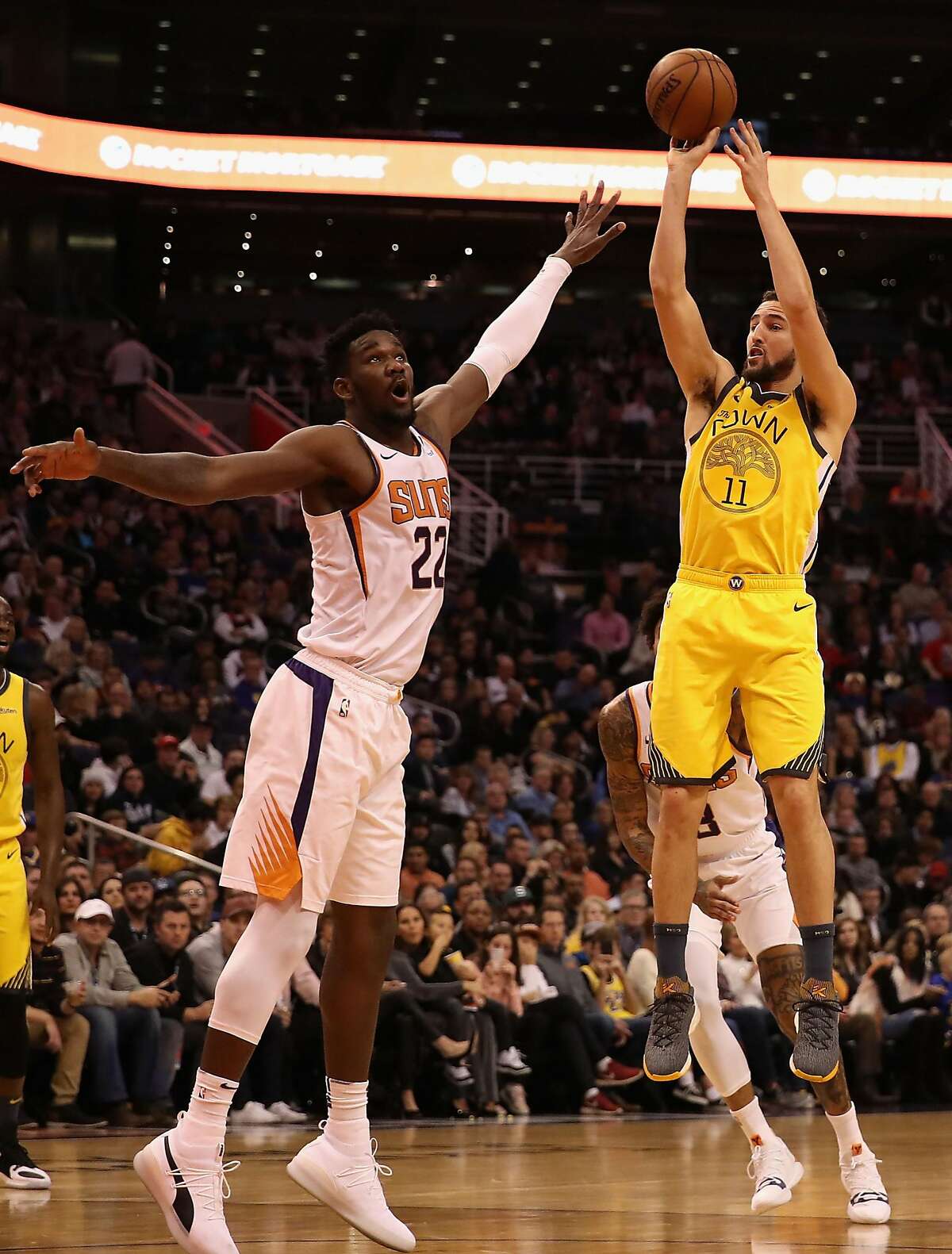 PHOENIX, ARIZONA - DECEMBER 31: Klay Thompson #11 of the Golden State Warriors puts up a shot over Deandre Ayton #22 of the Phoenix Suns during the first half of the NBA game at Talking Stick Resort Arena on December 31, 2018 in Phoenix, Arizona. The Warriors defeated the Suns 132-109. (Photo by Christian Petersen/Getty Images)