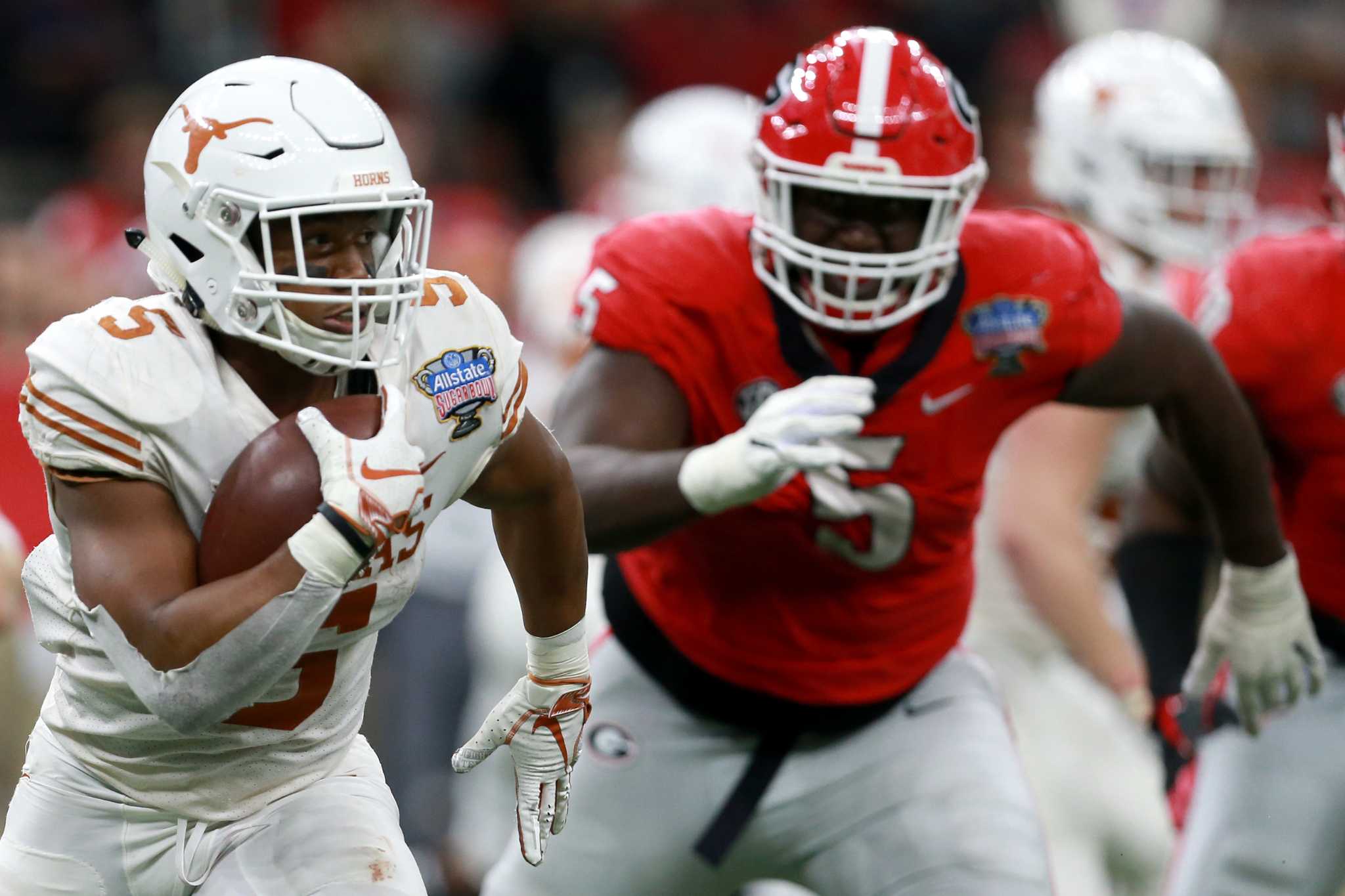 Ehlinger runs for 3 scores as Texas shocks Georgia in Sugar Bowl