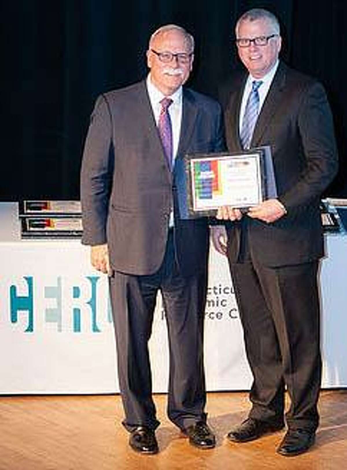 Makery Coworking in New Milford was recently recognized by The Connecticut Economic Resource Center, Inc. as one of 18 honorees who have contributed to the state's economy. Makery founder Tony Vengrove, right, is shown receiving the award.