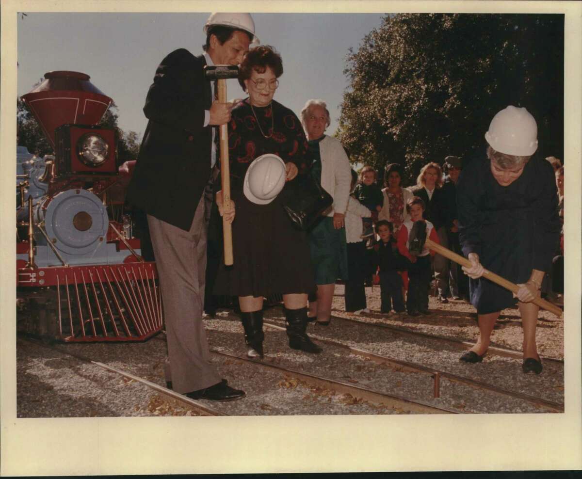 Councilman Frank Wing, from left, Lila Cockrell, Sister Peggy Gorman of the Daughters of Charity of St. Vincent de Paul rededicate the new trains at Brackenridge Park during a “Golden Spike Ceremony.”