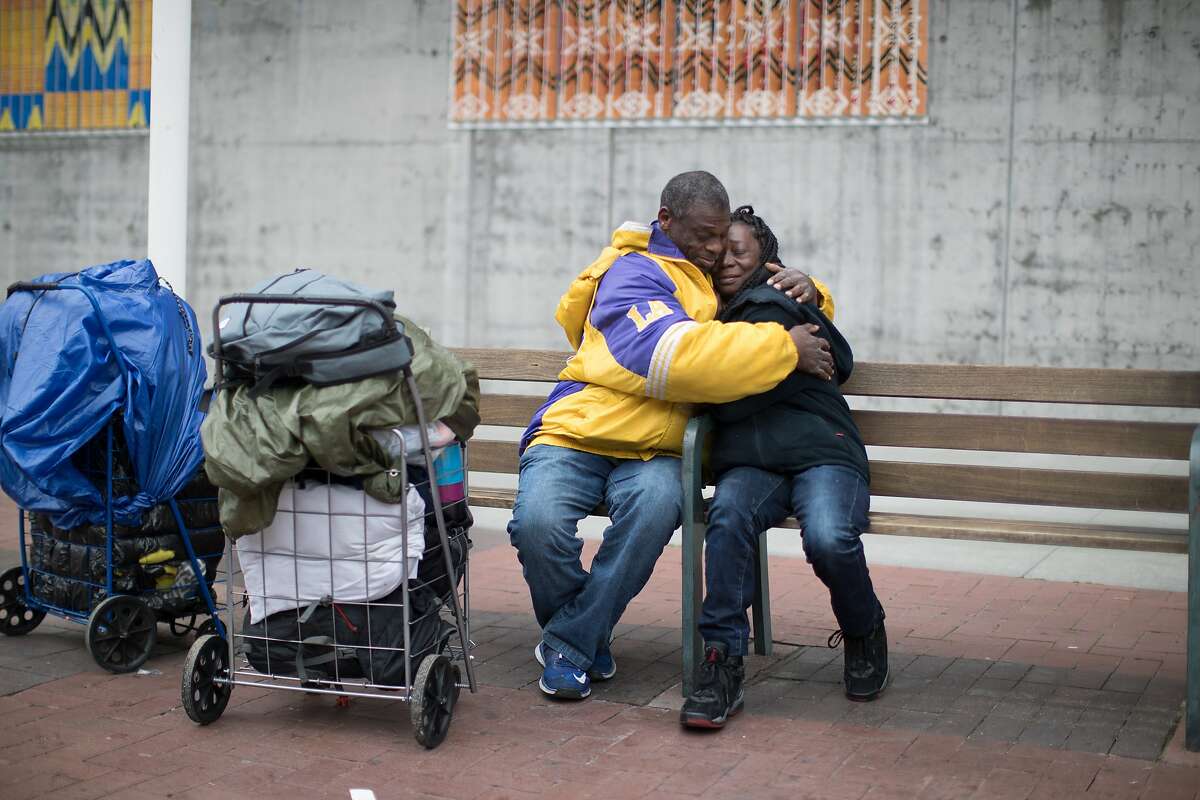 Gregory Dunston Sr. and Marie McKinzie embrace in front of the Amtrak station on Thursday, Dec. 20, 2018, in Oakland, Calif.