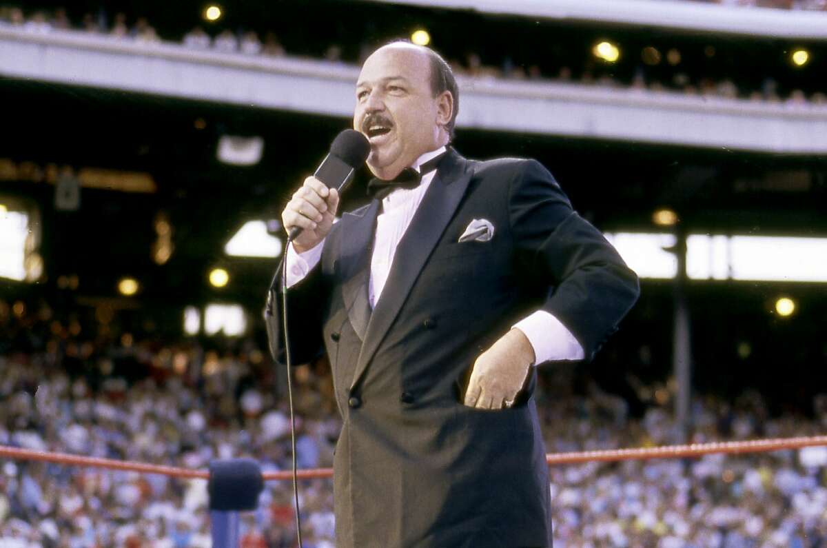 In this July 31, 1988 photo provided by the WWE, "Mean" Gene Okerlund addresses the crowd before a pro wrestling event in Milwaukee. Okerlund, who interviewed pro wrestling superstars "Macho Man" Randy Savage, The Ultimate Warrior and Hulk Hogan, has died. He was 76. WWE announced Okerlund's death on its website Wednesday, Jan. 2, 2019. (WWE via AP)