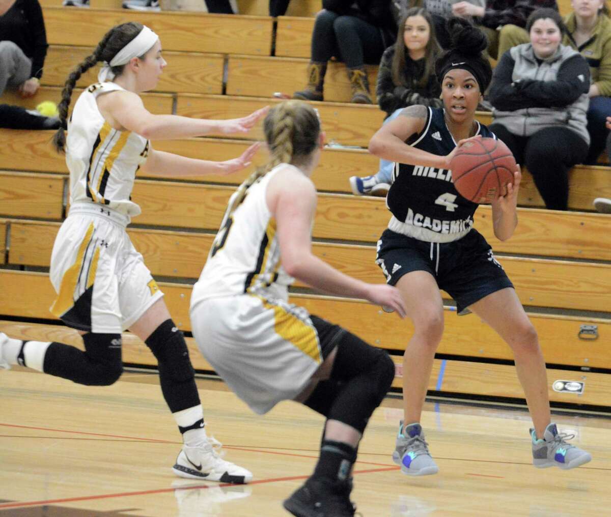 Hillhouse’s Ciara Little (4) looks to make a pass while defended by a pair of Amity defenders on Wednesday.