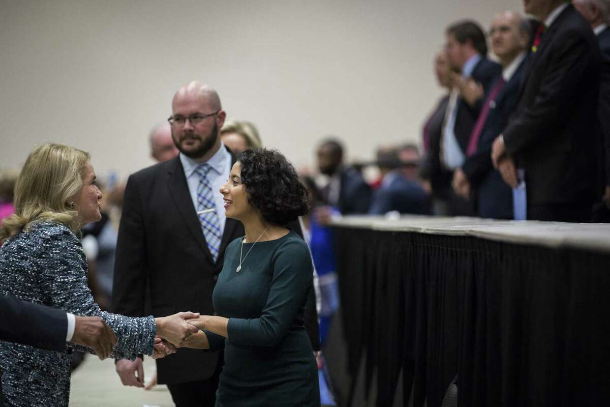 Newly elected Harris County judge Lina Hidalgo, right, and newly elected U.S. Rep. Sylvia Garcia, left, shake hands as Hidalgo enters the stage along with other newly sworn in Harris County officials during the Harris County Swearing-In Ceremony and Celebration at the NGR Center on Tuesday, Jan. 1, 2019, in Houston.