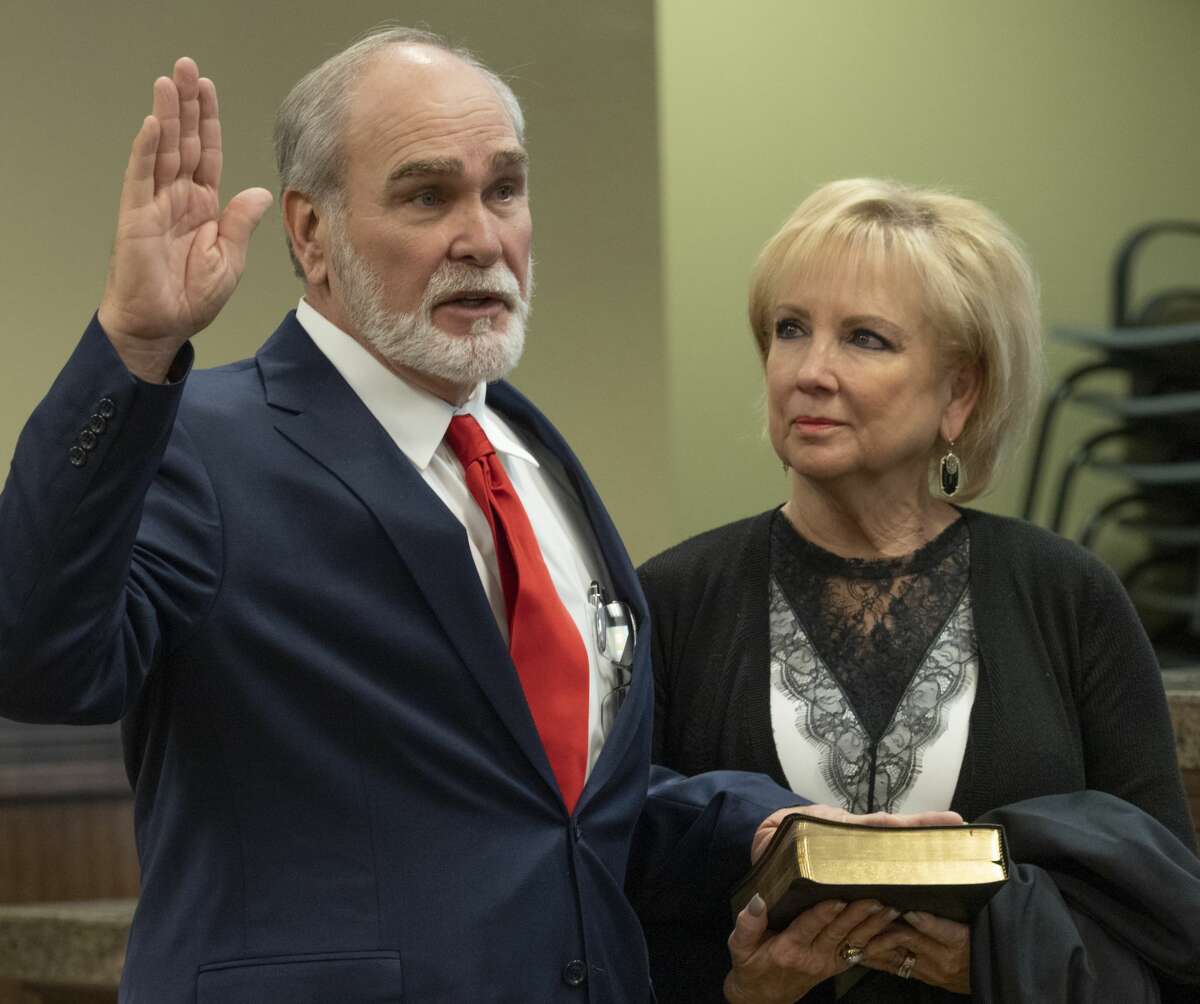 Judge Dean Rucker administers the oath of office to Judge Terry Johnson 01/03/19 as his wife Paula holds his Bible during the Investiture Ceremony at Midland County Courthouse. Tim Fischer/Reporter-Telegram