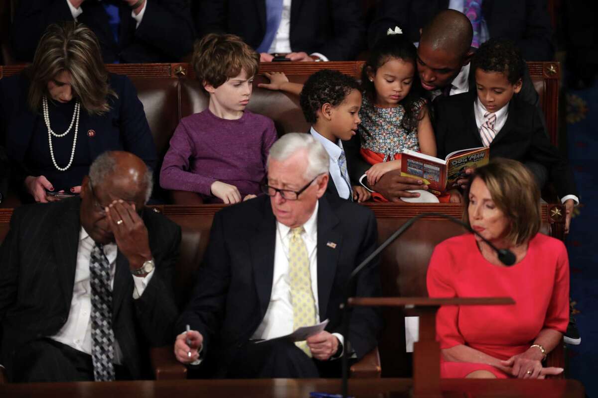 WASHINGTON, DC - JANUARY 3: Rep-elect Antonio Delgado (D-NY) reads to children as (Bottom Row, L-R) House Assistant Democratic Leader Rep. James Clyburn (D-SC) , House Minority Whip Steny Hoyer (D-MD), and Speaker-designate Rep. Nancy Pelosi (D-CA) look on during the first session of the 116th Congress at the U.S. Capitol January 03, 2019 in Washington, DC. Under the cloud of a partial federal government shutdown, Pelosi will reclaim her former title as Speaker of the House and her fellow Democrats will take control of the House of Representatives for the second time in eight years.