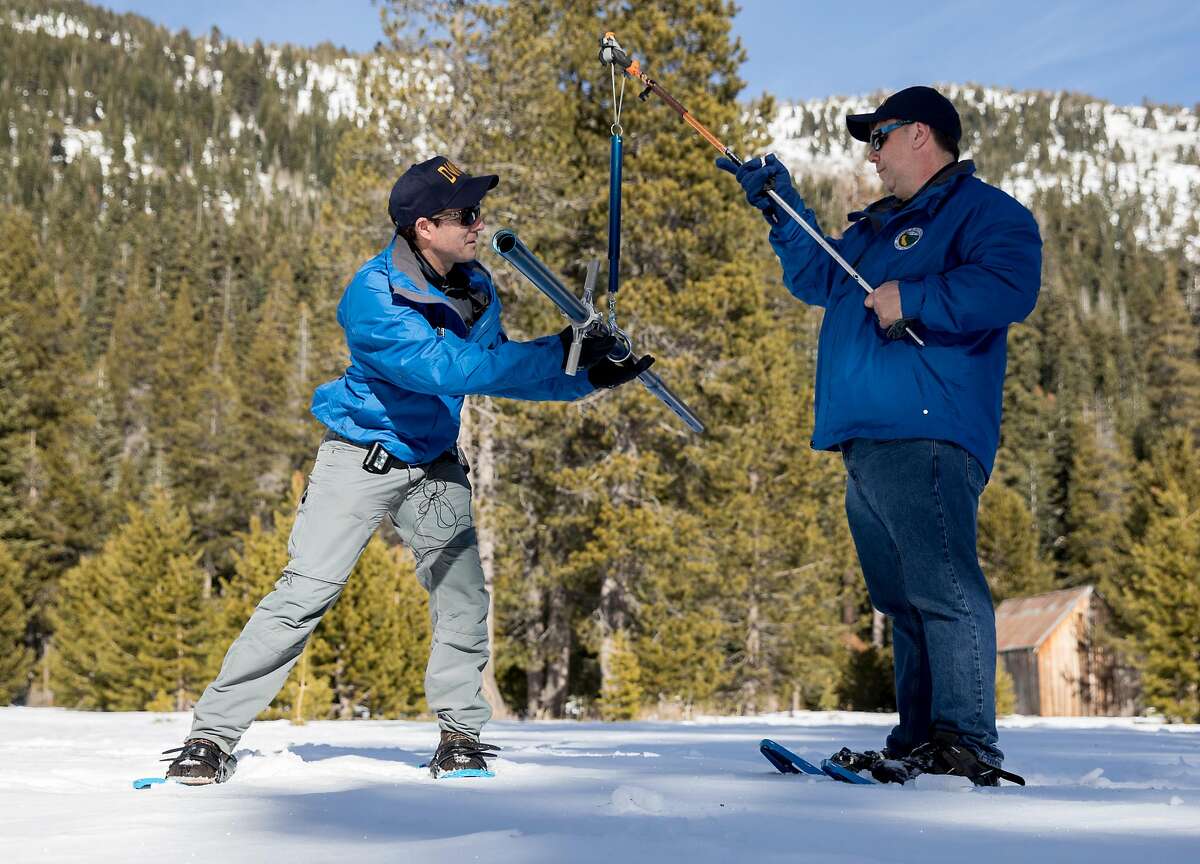 Department of Water Resources engineer John King (left) and state climatologist Michael Anderson conduct the first snow survey measurement of the year in Phillips, Calif. Thursday, Jan. 3, 2019.