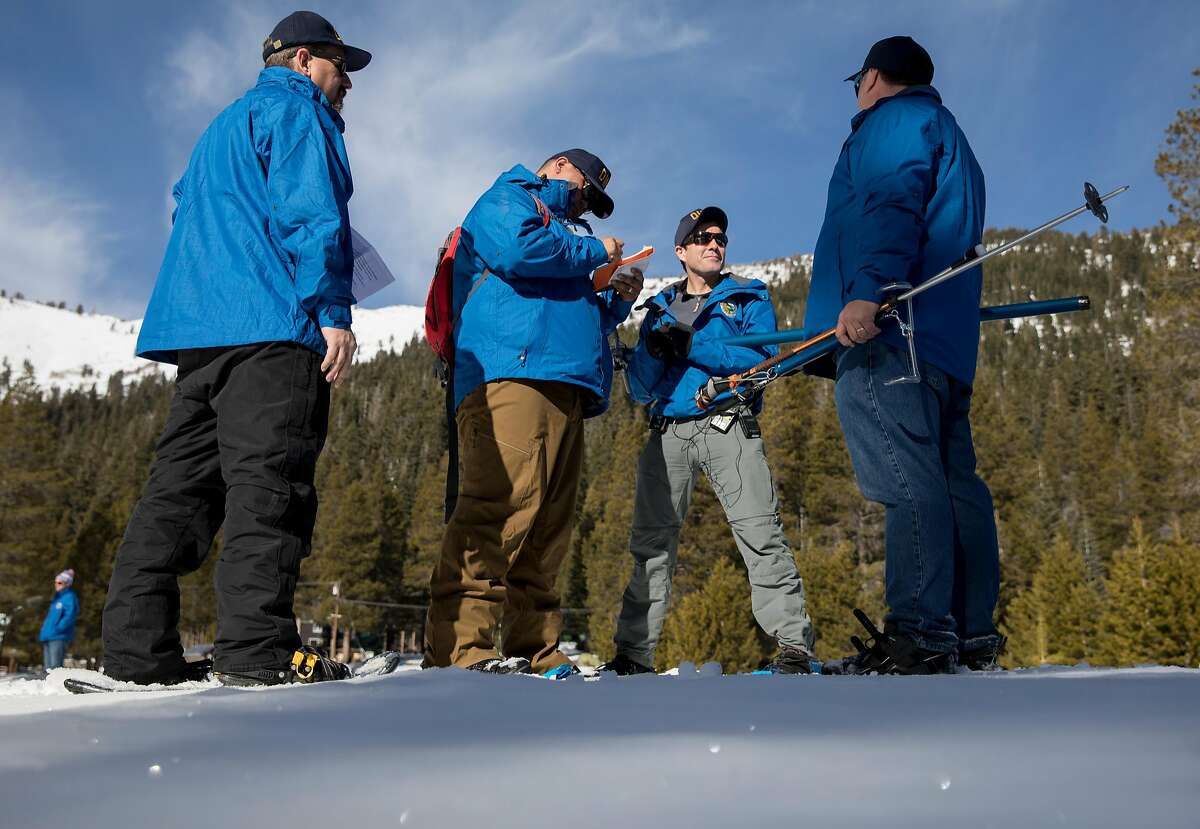 (From left) Department of Water Resources information officer Chris Orrock, water resources engineer Sean de Guzman, water resources engineer John King, and state climatologist Michael Anderson conduct the first snow survey measurement of the year in Phillips, Calif. Thursday, Jan. 3, 2019.