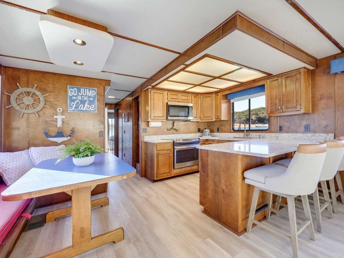 The interior of the boat has a kitchen, and a...