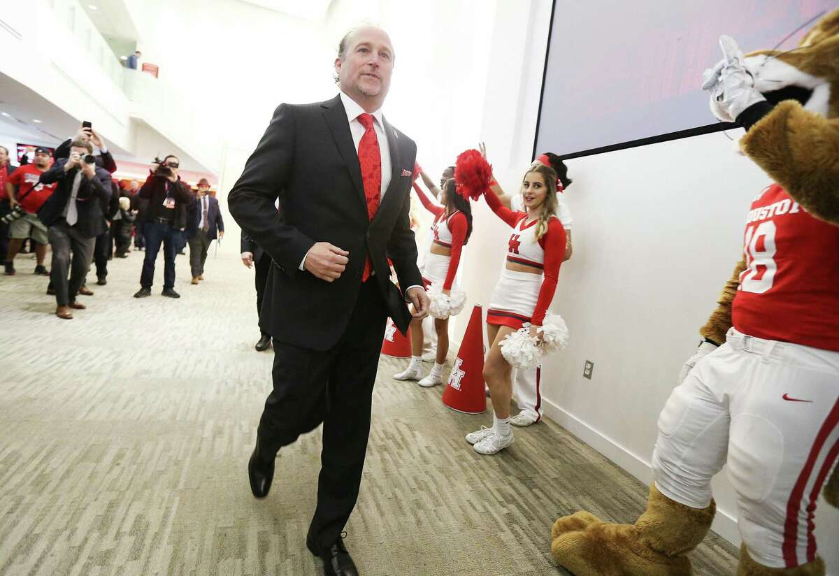 PHOTOS: Everything you need to know about Houston's new head football coach Dana Holgorsen  University of Houston's new head football coach, Dana Holgorsen, makes his way to the podium for a press conference at TDECU Stadium on Thursday, Jan. 3, 2019 in Houston. >>>Browse through the gallery to learn more about the Cougars' new head football coach ... 