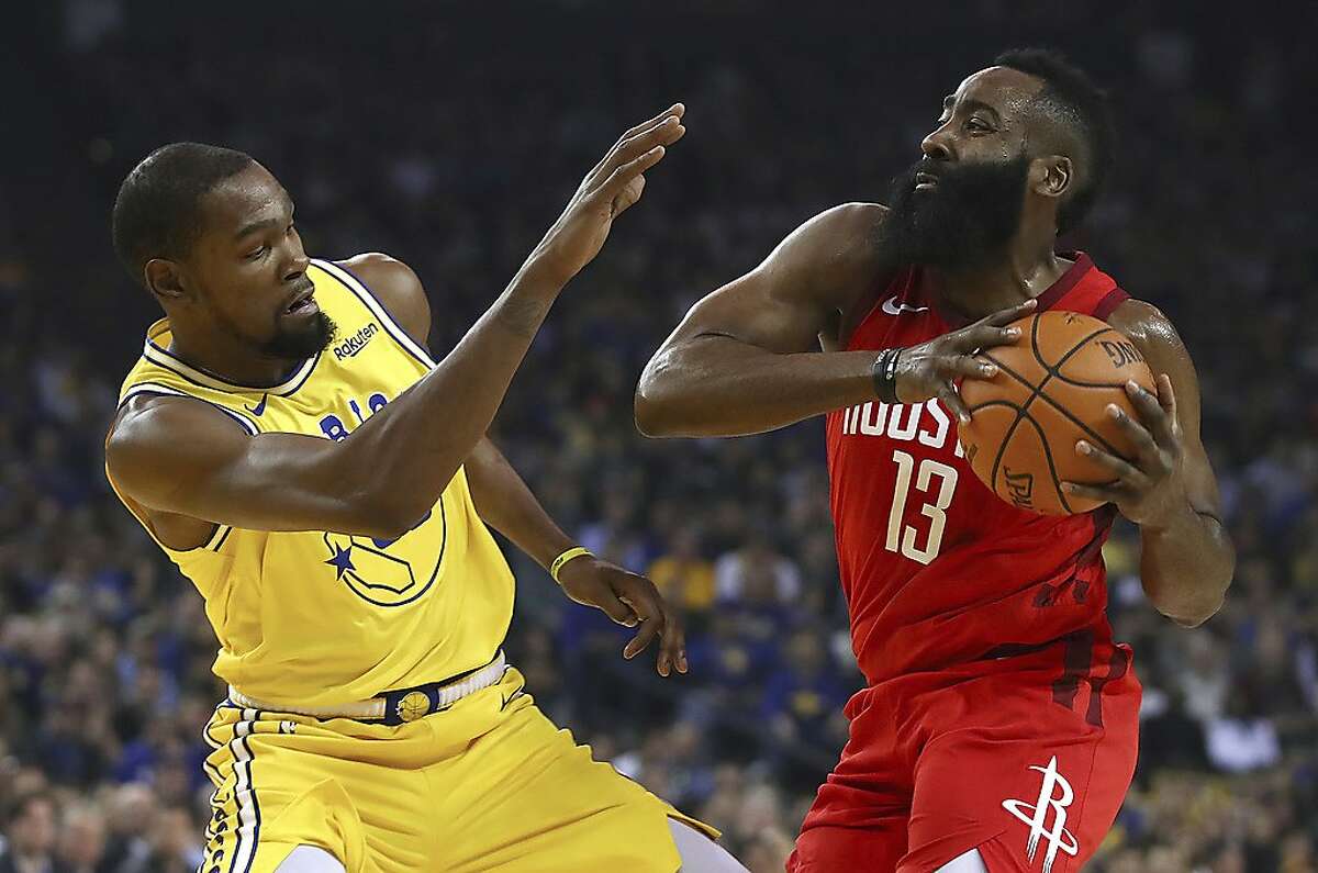 Golden State Warriors' Kevin Durant, left, defends against Houston Rockets' James Harden during the first half of an NBA basketball game Thursday, Jan. 3, 2019, in Oakland, Calif. (AP Photo/Ben Margot)