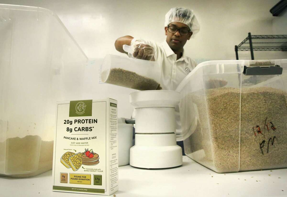 Grain4Grain co-founder Yoni Medhin prepares to grind spent barley into flour to be used in a pancake mix, on Wednesday, Jan. 2, 2019.