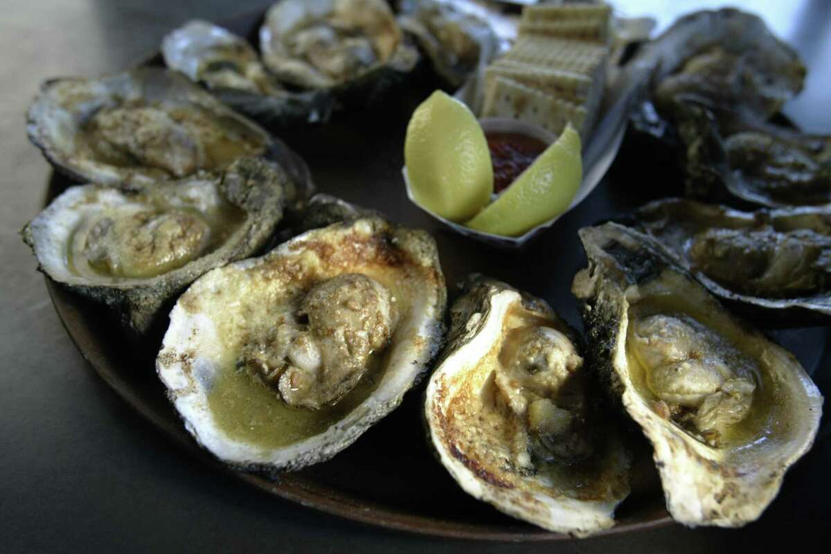 Oysters are roasted with garlic butter and parmesan at Gilhooley’s in San Leon.