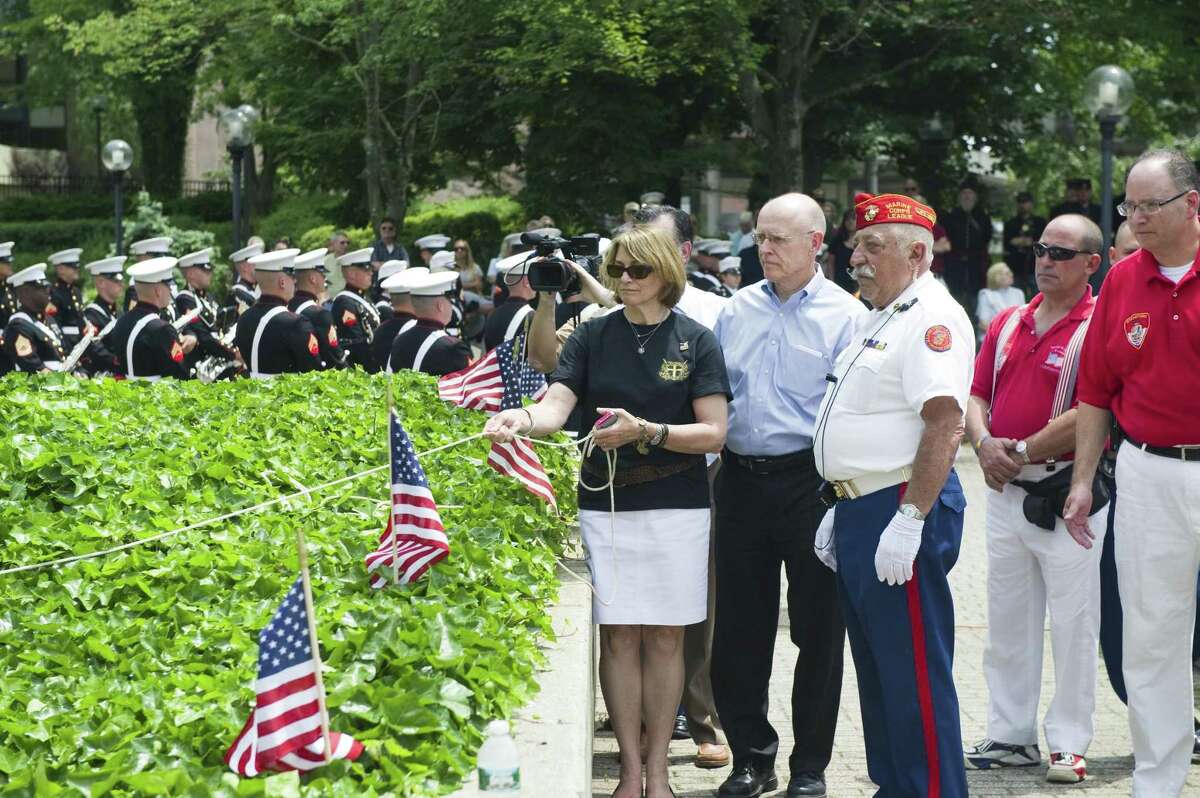 Patricia and Michael Parry reveal the inscription of their son, Navy SEAL Brian Bill, on the memorial wall at Veterans Park in 2012.