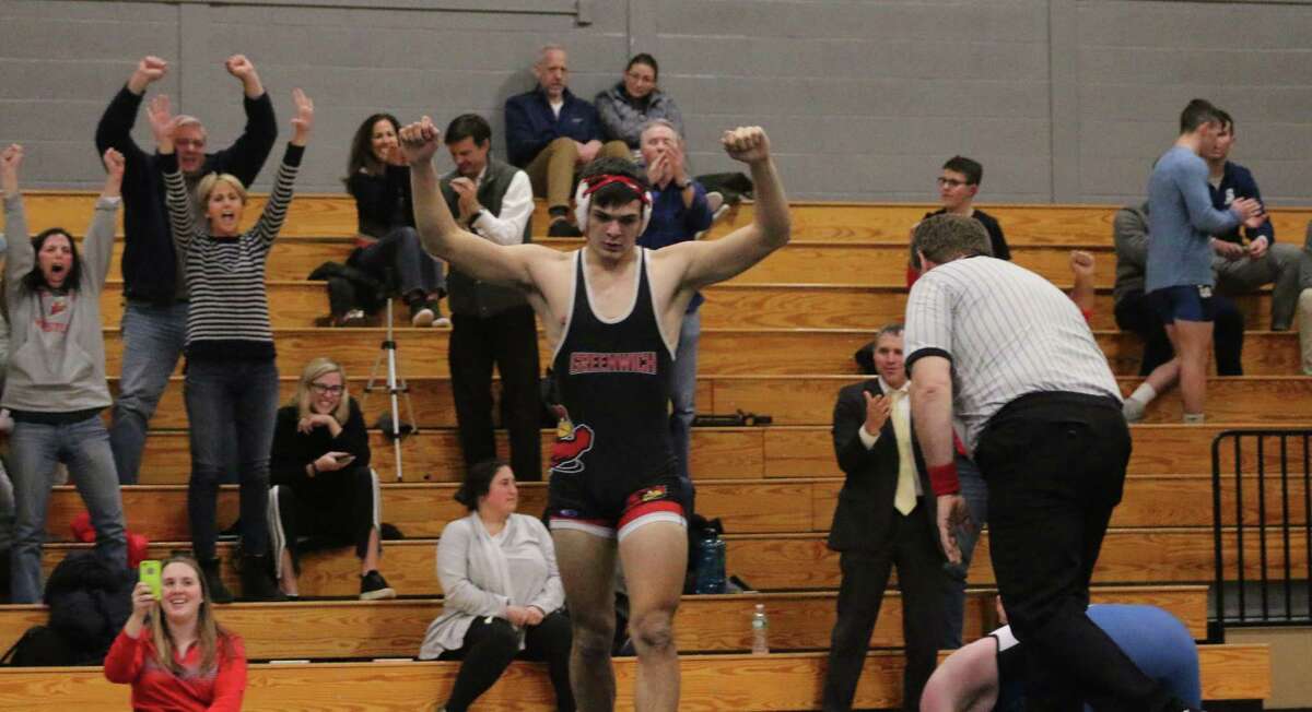 Greenwich senior Andrew Nanai reacts after he won his match against Staples by pinfall, resulting in a 38-36 Cardinals win against the Wreckers on Wednesday.