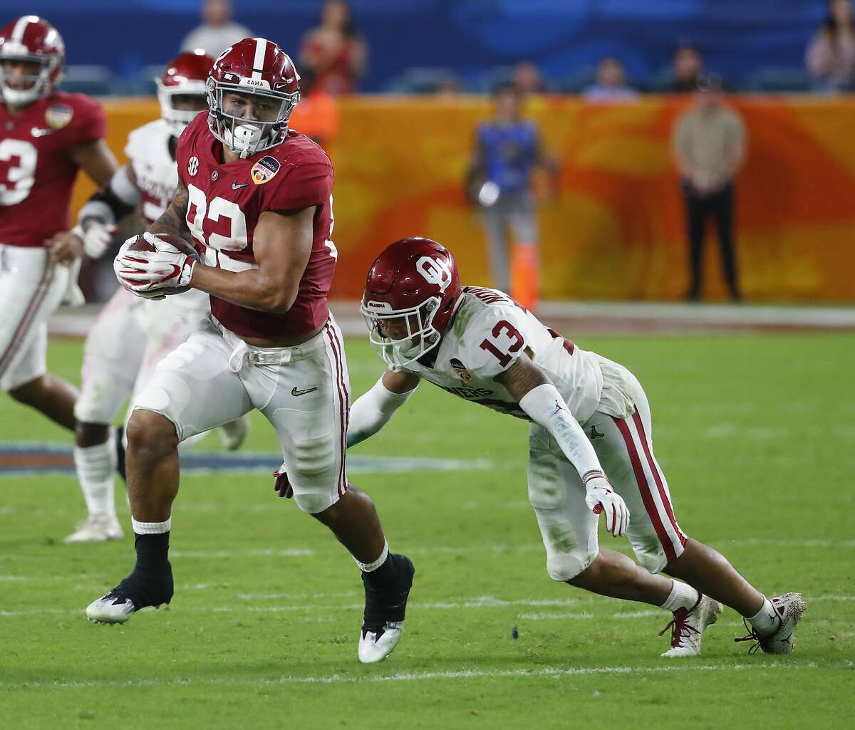 Alabama tight end Irv Smith Jr. (82) runs the ball as Oklahoma cornerback Tre Norwood (13) attempts to tackle, during the second half of the Orange Bowl NCAA college football game, Saturday, Dec. 29, 2018, in Miami Gardens, Fla. (AP Photo/Wilfredo Lee)