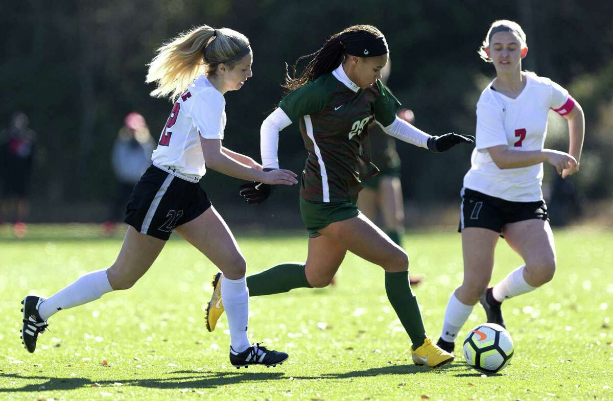 The Woodlands midfielder Shianne Knight (29) dribbles the ball between Tyler Lee defender Ariel Hekier (22) and midfielder Meghan Romines (7) in the second period of a match during the Lady Highlander Invitational at Gosling Sports Complex, Friday, Jan. 4, 2019, in The Woodlands.
