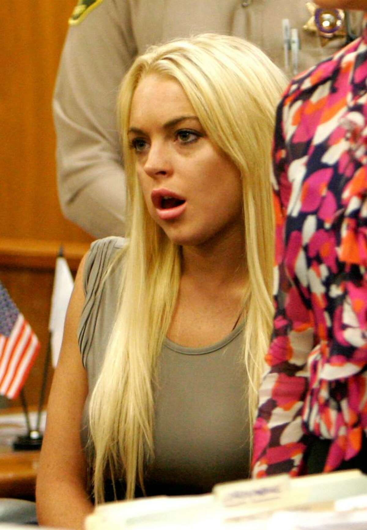BEVERLY HILLS, CA - JULY 20: Actress Lindsay Lohan surrenders at the Beverly Hills Courthouse to serve her 90 day jail sentence on July 20, 2010 in Beverly Hills, California. Lindsay Lohan was found in violation of her probation for the August 2007 no-contest plea to drug and alcohol charges stemming from two separate traffic accidents. (Photo by Al Seib-Pool/Getty Images) *** Local Caption *** Lindsay Lohan