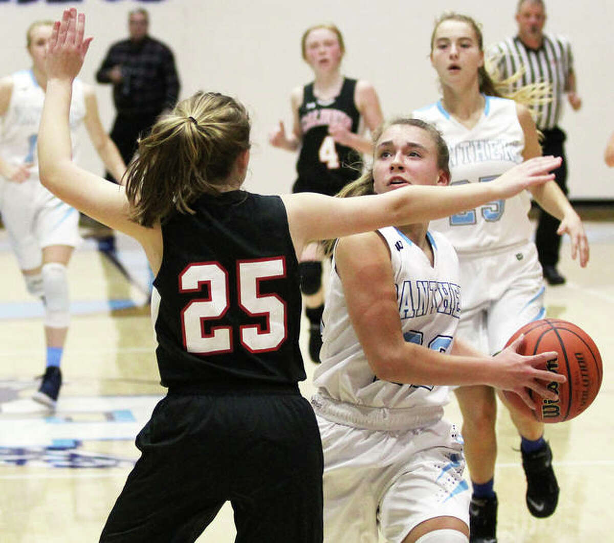 Jersey’s Clare Breden goes up to score over Calhoun’s Ashleigh Presley (25) in a Jersey Tourney game Dec. 27 in Jerseyville. Breden scored 21 points Saturday in a Panthers victory at the Breese Central Shootout.