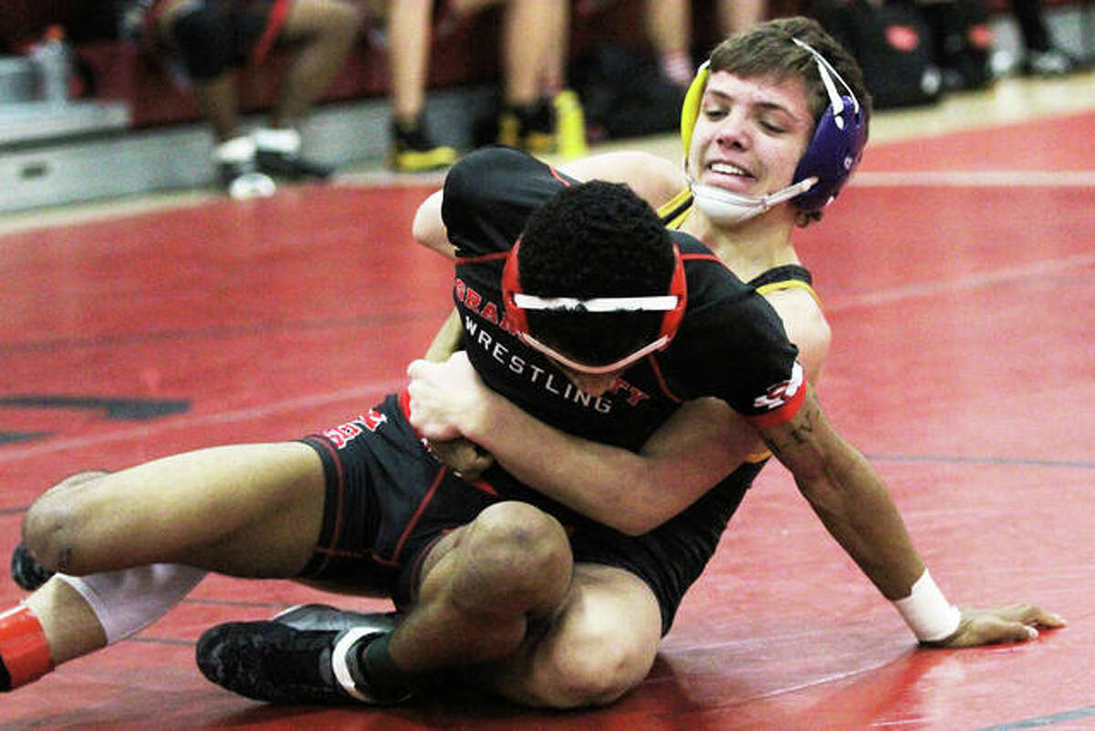 Civic Memorial sophomore Caleb Tyus (back) controls his Granite City opponent during a Dec. 20 dual in Granite City. On Saturday, Tyus improved his record to 21-1 with the 120-pound title at the Murdale Tourney in Carbondale.