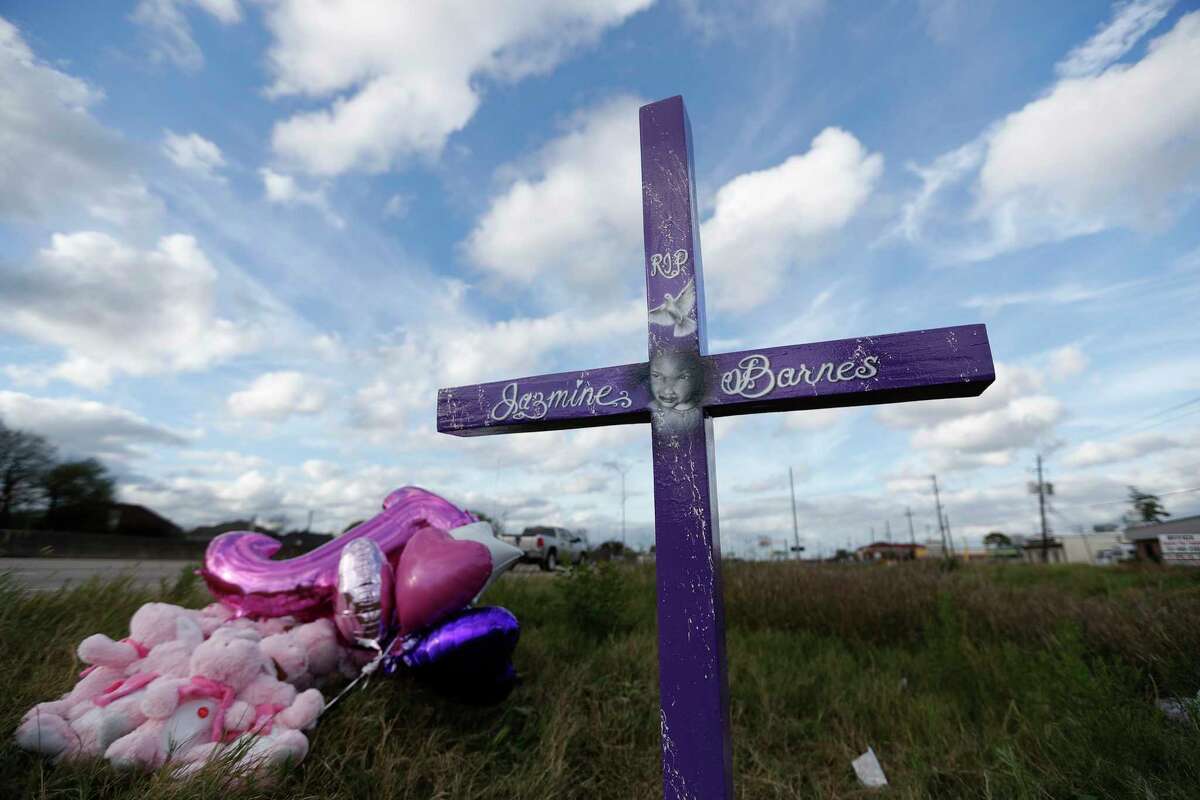 A purple cross put up for Jazmine Barnes on Beltway 8 near the Wallisville Road exit, Sunday, Jan. 6, 2019, in Houston. Jazmine was shot and killed in a drive-by shooting in the area.