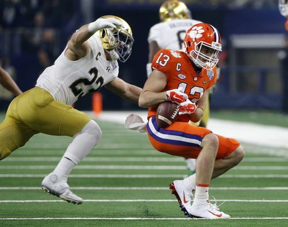 Notre Dame linebacker Drue Tranquill (23) prepares to wrap up Clemson wide receiver Hunter Renfrow (13) after a catch in the first half of the NCAA Cotton Bowl semi-final playoff football game, Saturday, Dec. 29, 2018, in Arlington, Texas. (AP Photo/Michael Ainsworth)
