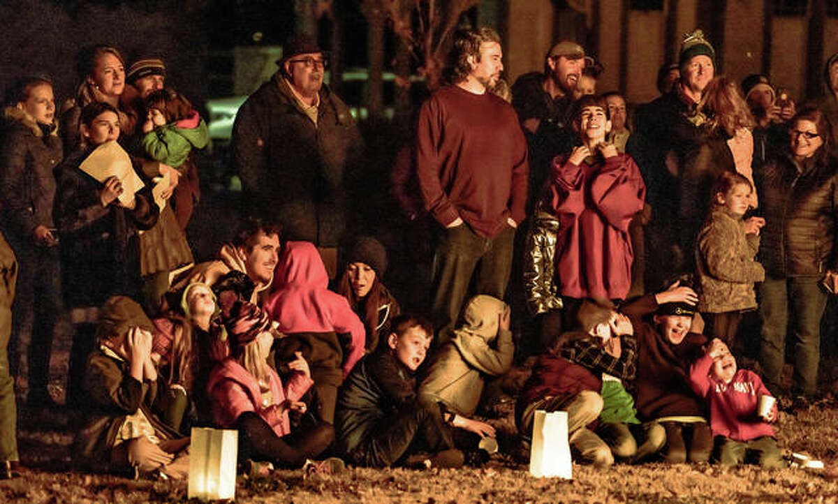 Children react to the intense bonfire created by the burning of Christmas trees during the Twelfth Night celebration in Haskell Park Sunday evening. The Alton Fire Department assisted in the ceremony and made sure guests were safe during the annual event, signaling the end of the Christmas holiday.
