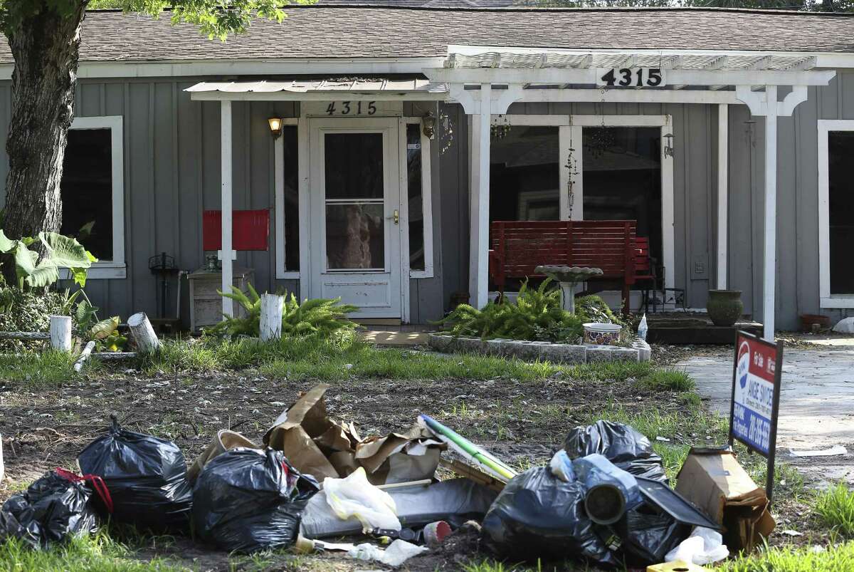 Discarded household materials are set on the yard of the house on 4300 block of Oleander Street on Wednesday, Oct. 11, 2017, in Bellaire. The neighborhood was damaged by Hurricane Harvey flood.
