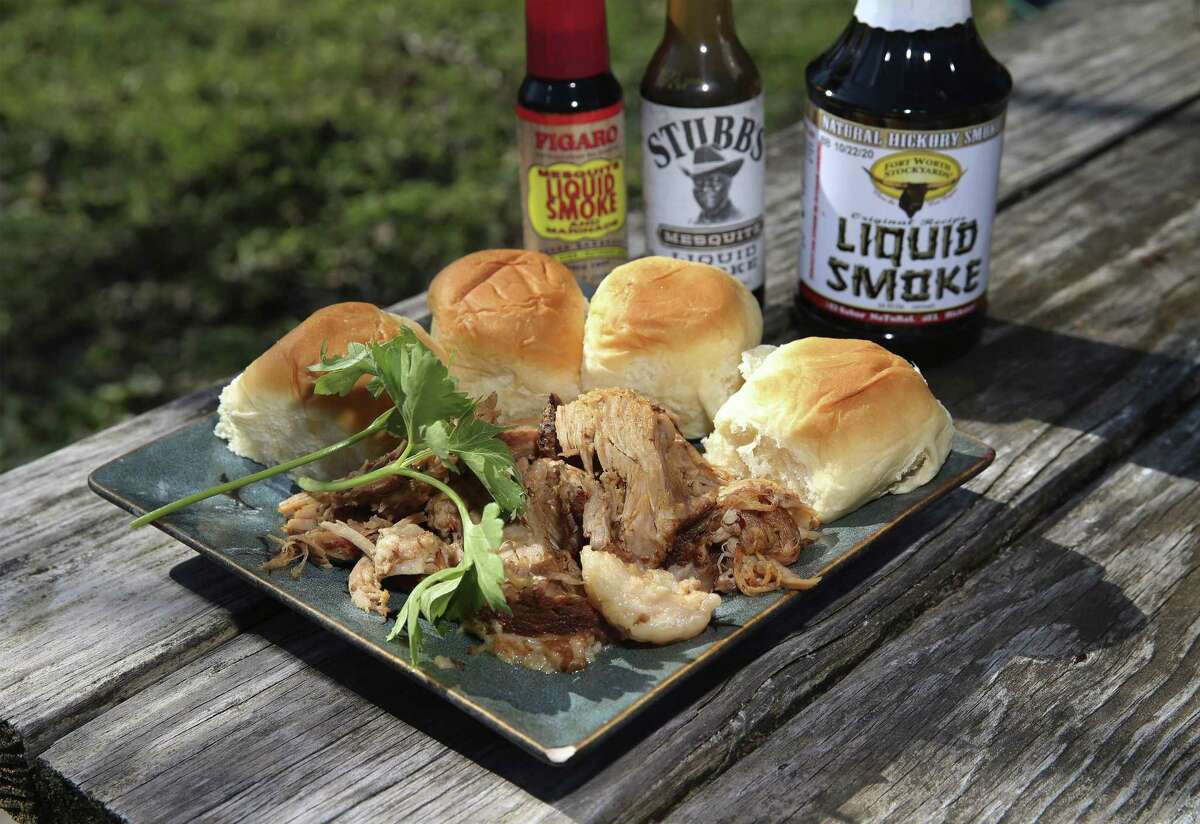 Pulled pork barbecue sliders made with picnic roast pork, liquid smoke and other ingredients in the slow cooker.