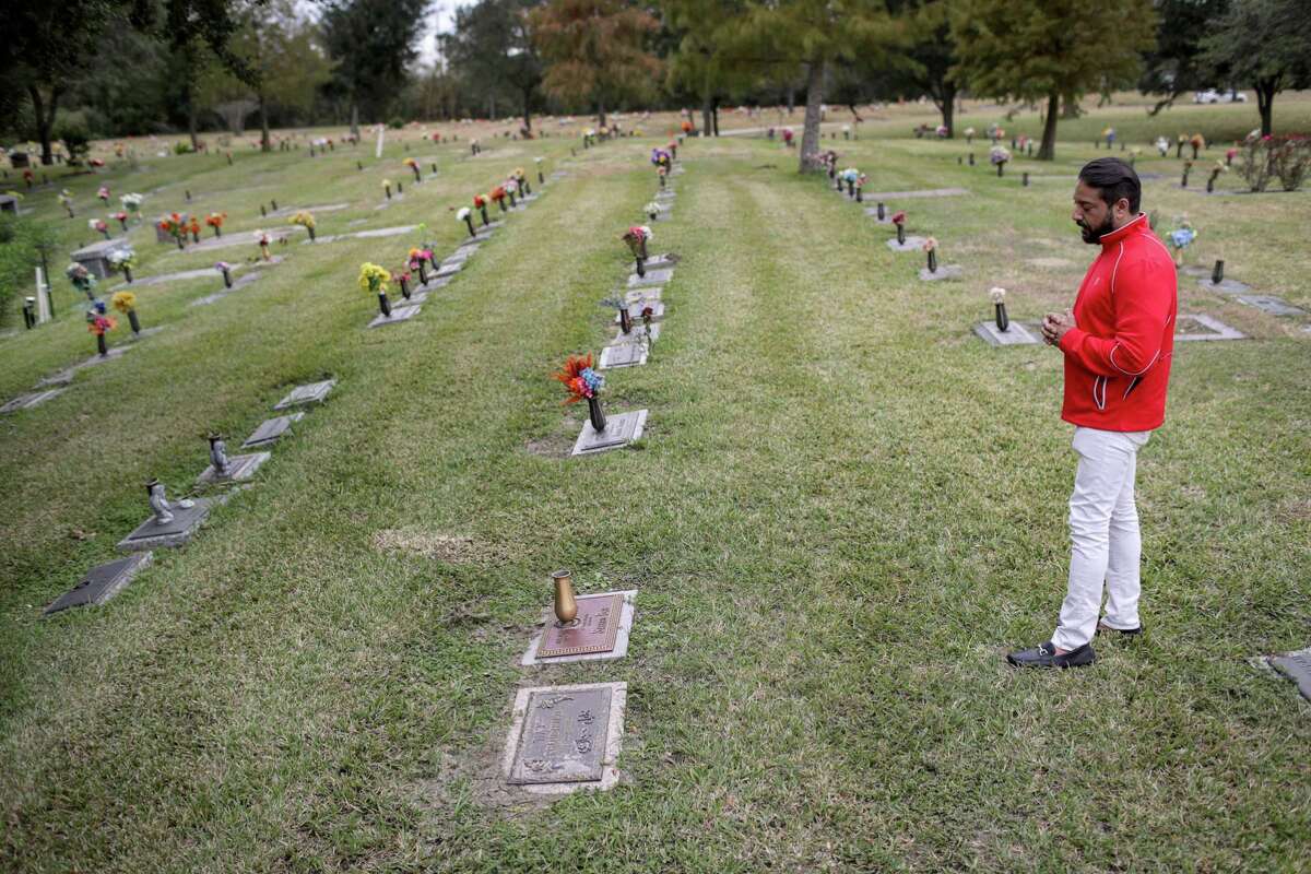 Yousuf Beg demonstrates how he prays at his father's grave at Forest Lawn Cemetery, Wednesday, Nov. 28, 2018, in Houston. Beg said that his father had no will when he died, which is a common occurrence in American-Muslim families.