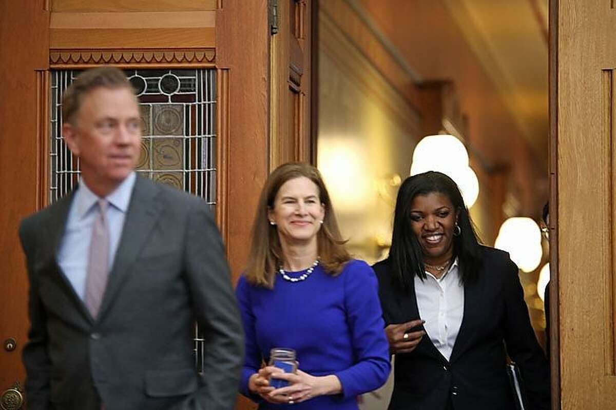 Vannessa Dorante, right, new commissioner of the state Department of Children and Families, walks out of a press conference Monday with Gov.-elect Ned Lamont and Lt. Gov.-elect Susan Bysiewicz.