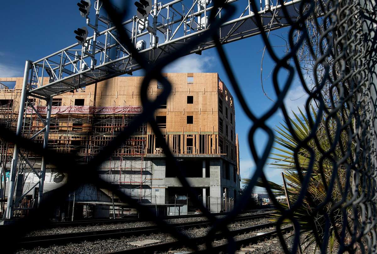 New construction is seen across the Diridon Station tracks near a fence adjacent to the SAP Center parking lot in San Jose, Calif. Friday, Jan. 4, 2019.