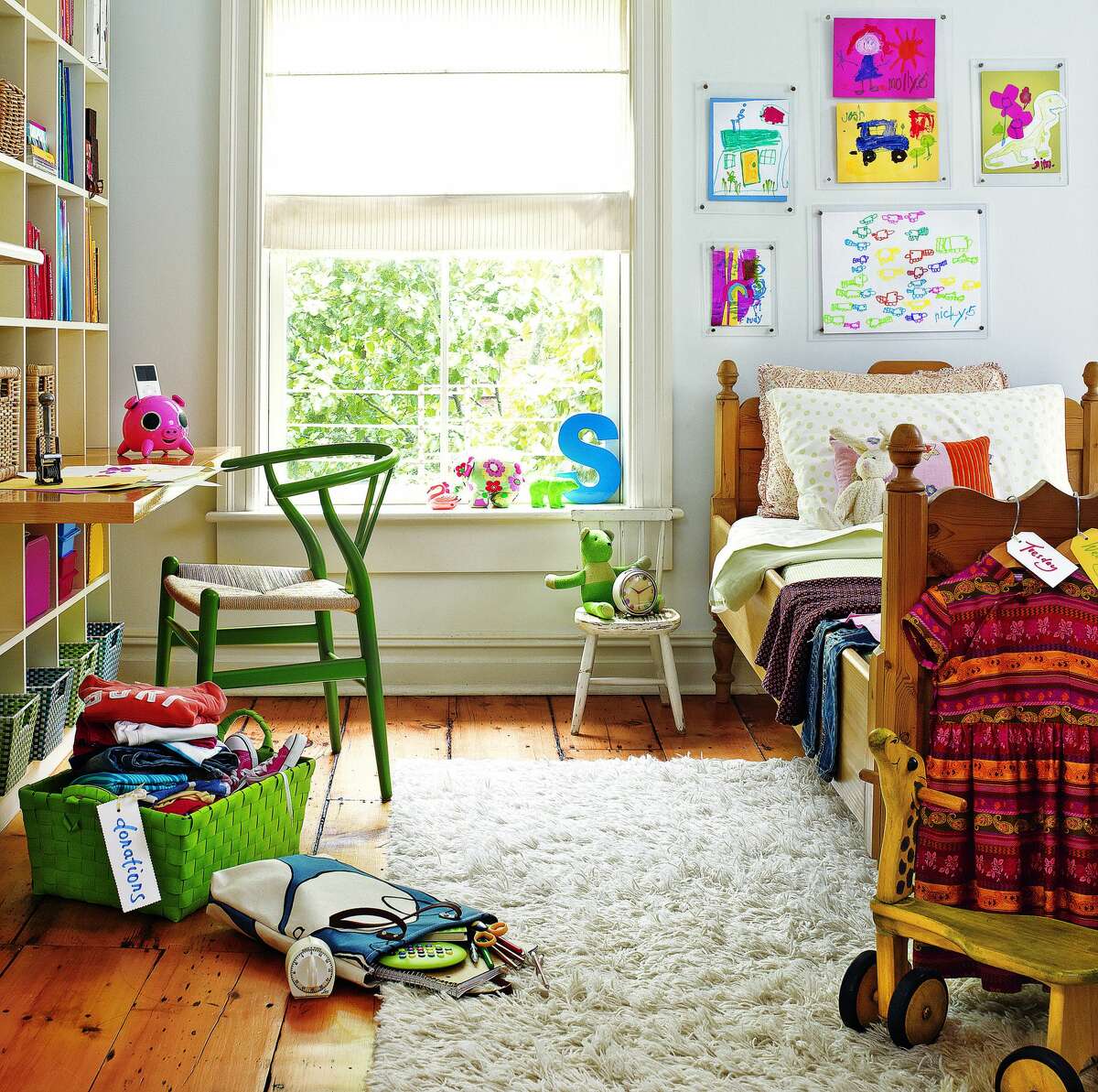 A wall of storage bins in a child's room teaches your kids the responsibility of picking up after themselves. If getting rid of clutter and having a tidier or more organized home is a goal for 2019, Real Simple's new "The Real Simple Method to Organizing Every Room" book offers plenty of advice.