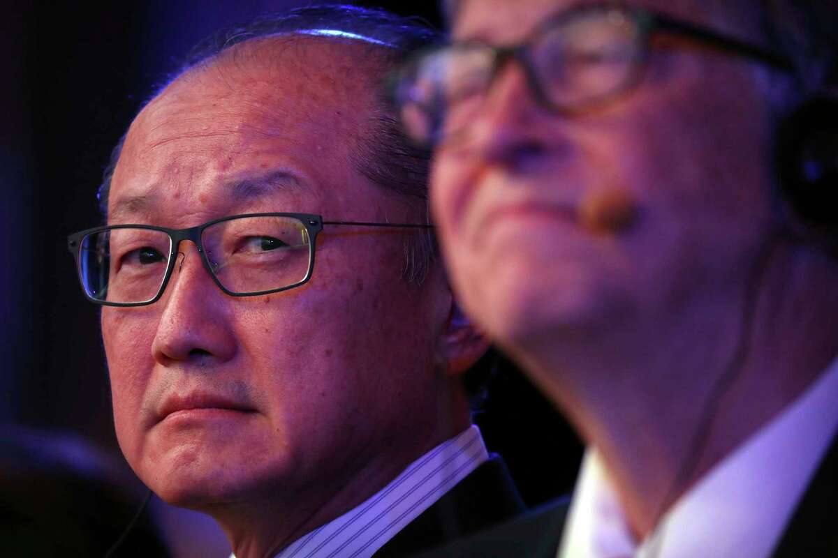FILE- In this Nov. 6, 2018, file photo World Bank President Jim Yong Kim, left, and Bill Gates, former Microsoft CEO and co-founder of the Bill and Melinda Gates Foundation, listen to a speaker at the Reinvented Toilet Expo in Beijing. Kim, the president of the World Bank, says he is resigning at the end of January. Kim's unexpected departure nearly three years before his term was set to expire, is likely to set off a fierce battle between the Trump administration and other countries who have complained about the influence the United States exerts over the World Bank. (AP Photo/Mark Schiefelbein, File)